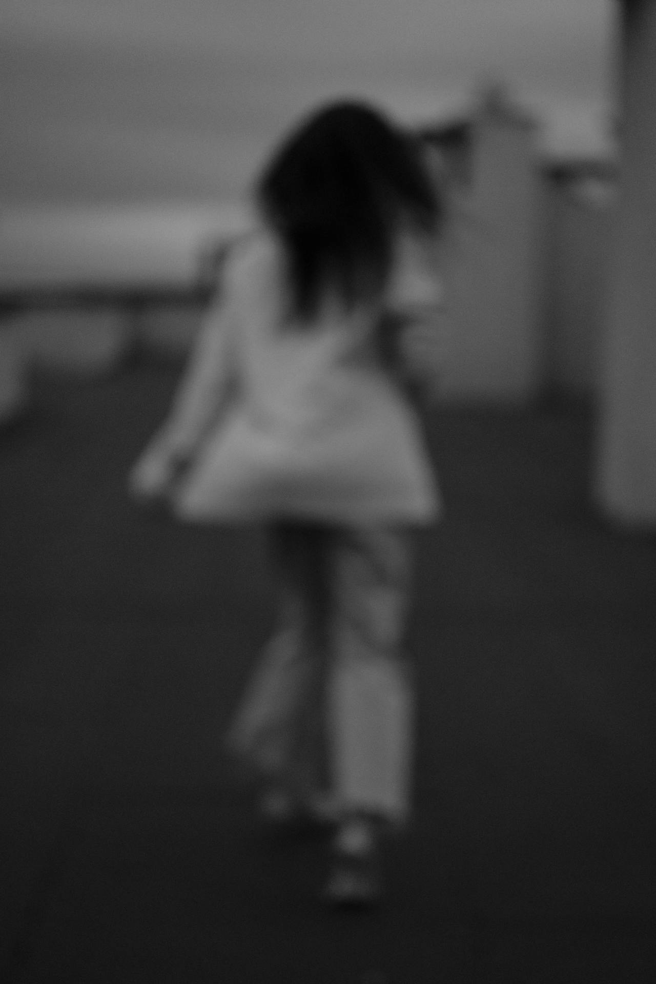 Grayscale shot of a woman running away | Source: Pexels