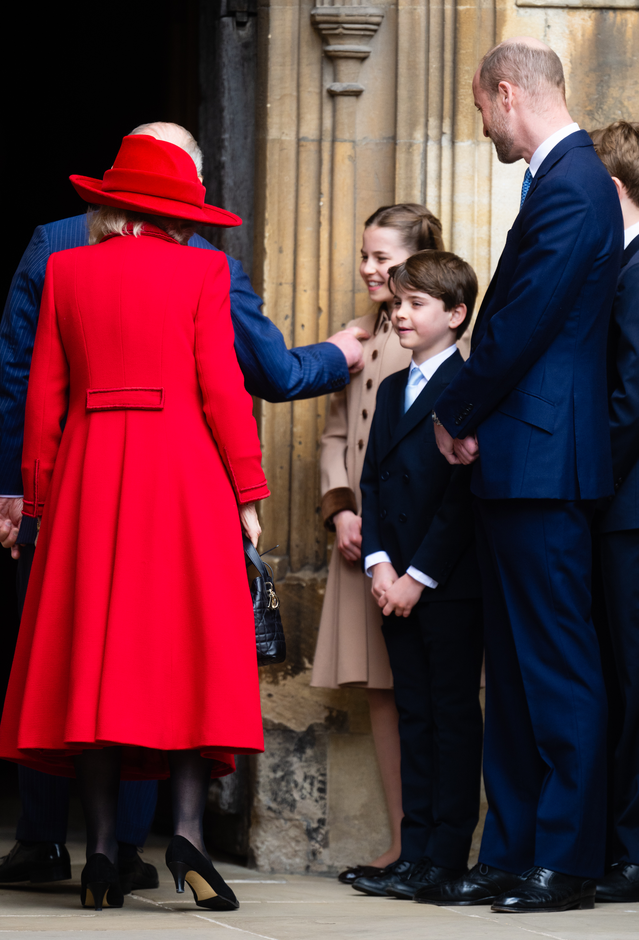 King Charles III and Queen Camilla greet Princess Charlotte of Wales, Prince Louis of Wales and Prince William, Prince of Wales as they attend the 2026 Easter Matins Service at St George's Chapel on April 05, 2026 in Windsor, England. | Source: Getty Images