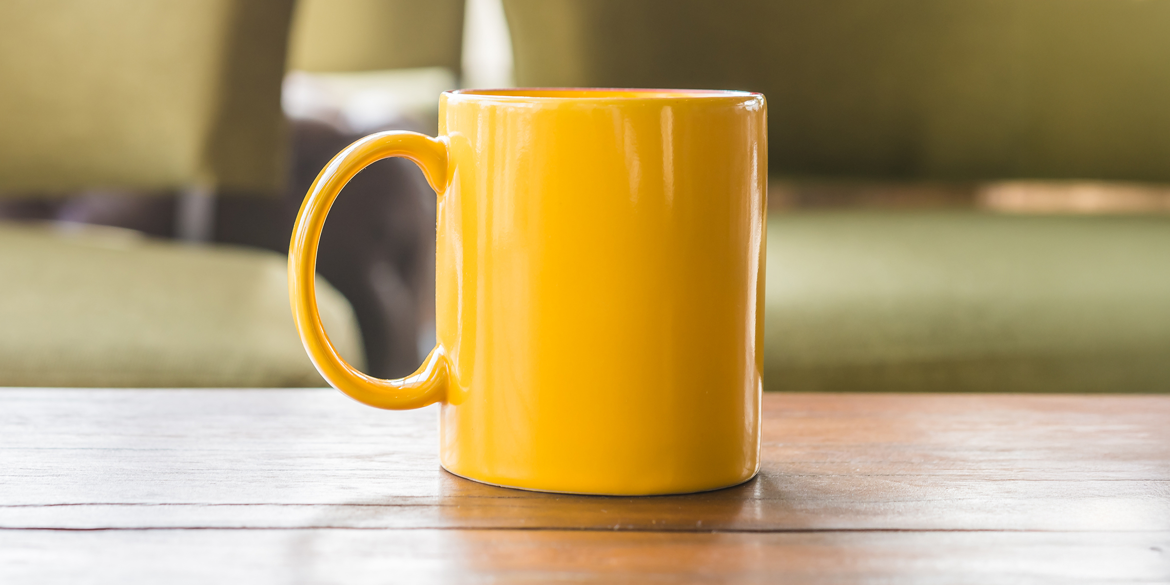 A yellow mug on a table | Source: Shutterstock