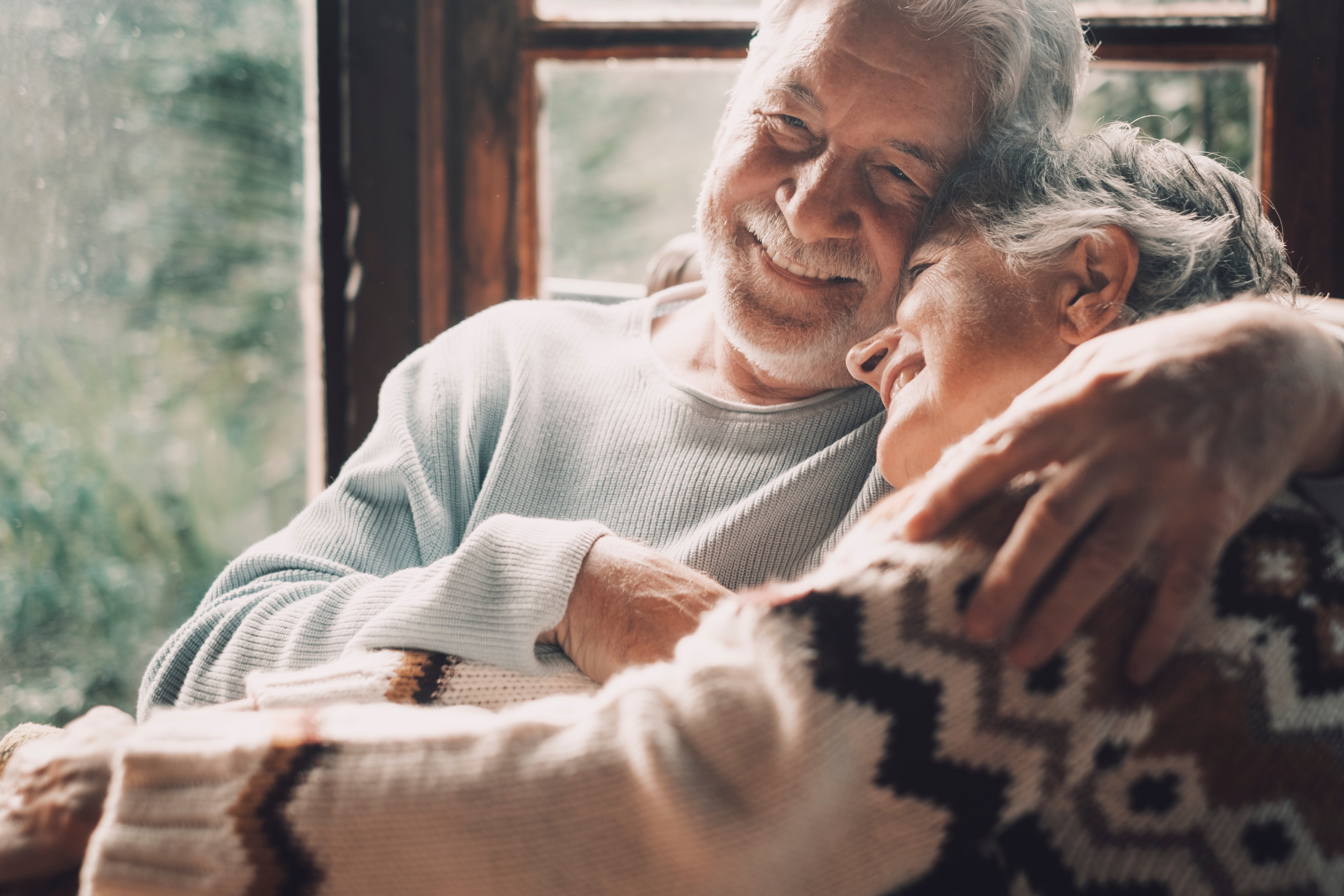 A happy senior couple embracing each other | Source: Shutterstock