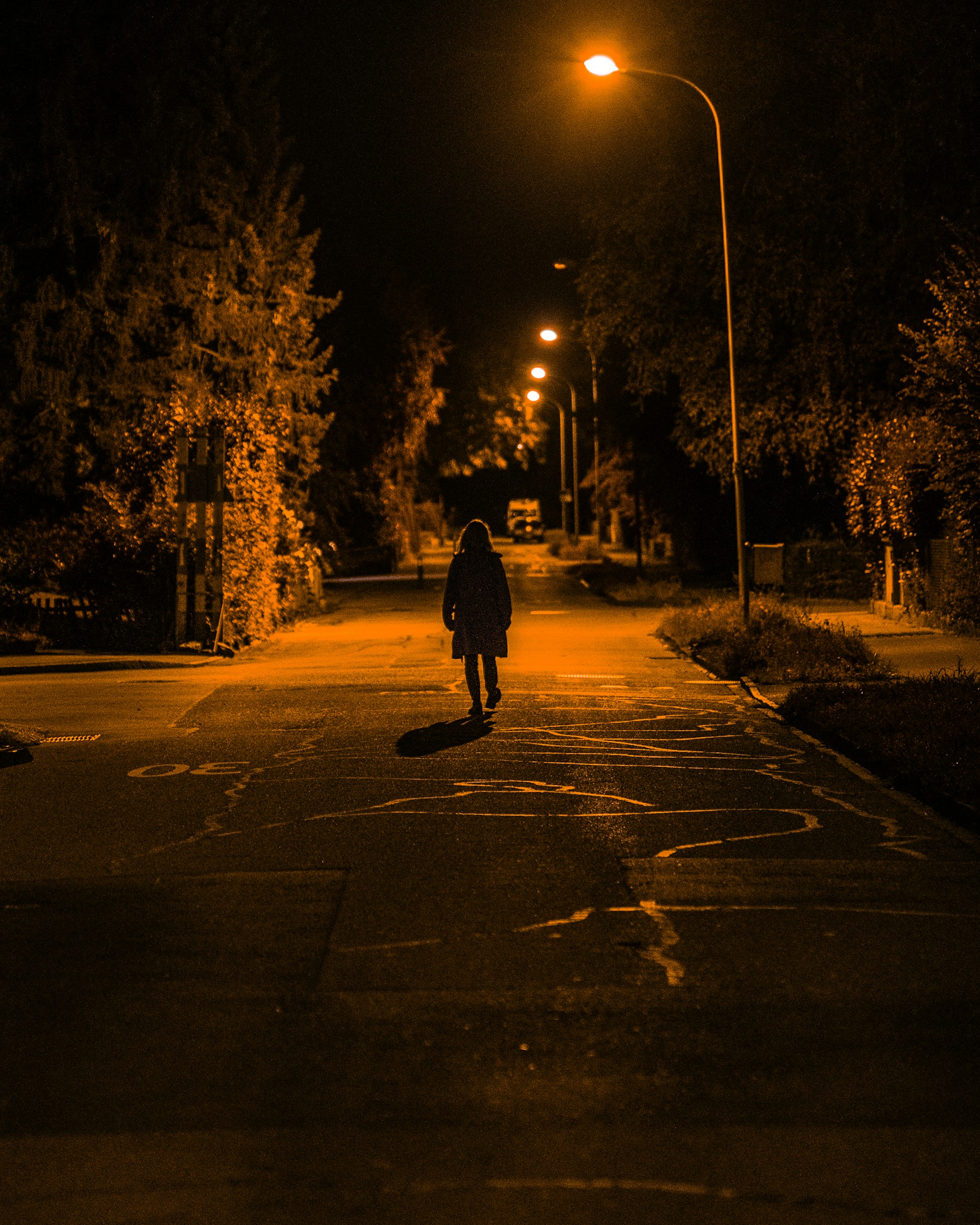 A lonely woman walking on the street at night | Source: Unsplash