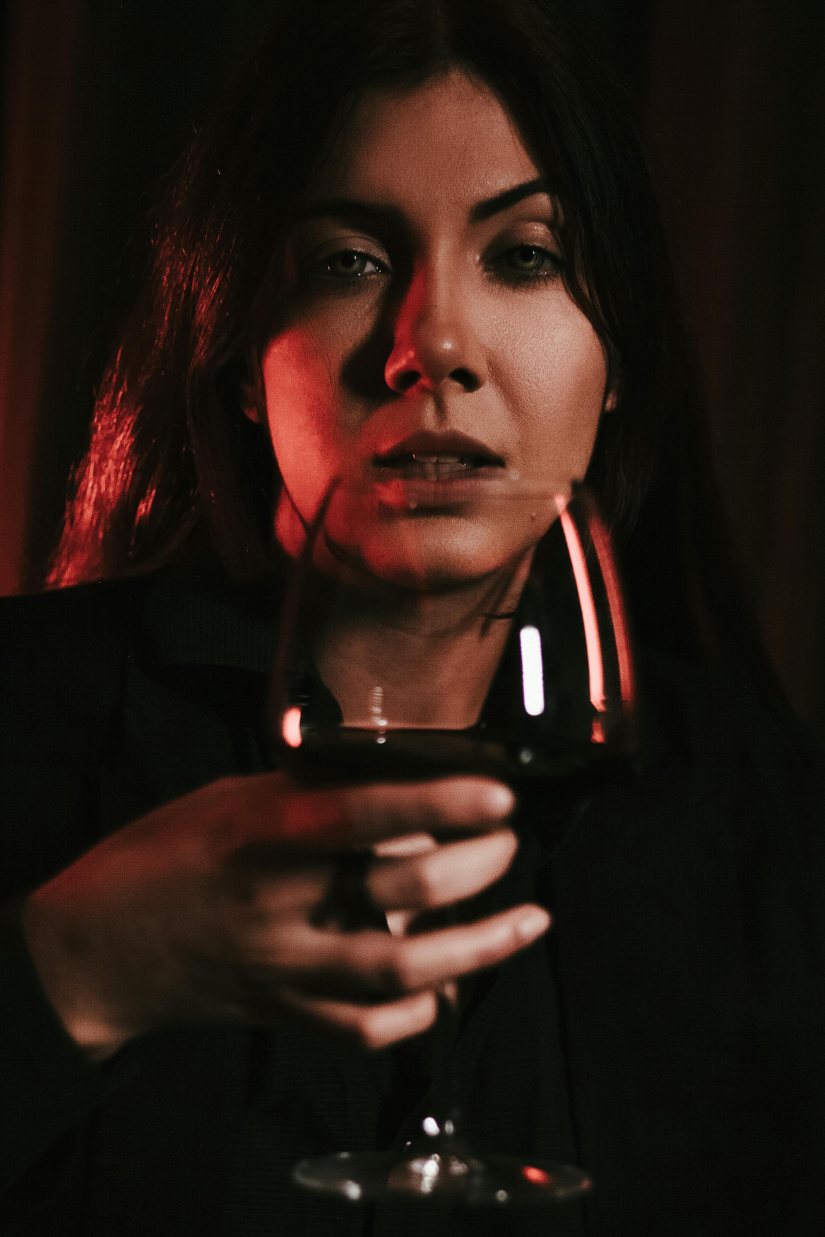 Woman holding a glass of wine | Source: Pexels