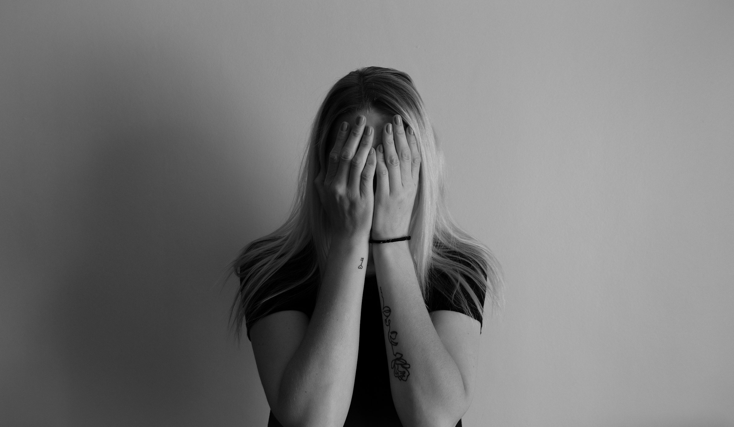 Woman covering her face with her hands | Source: Unsplash