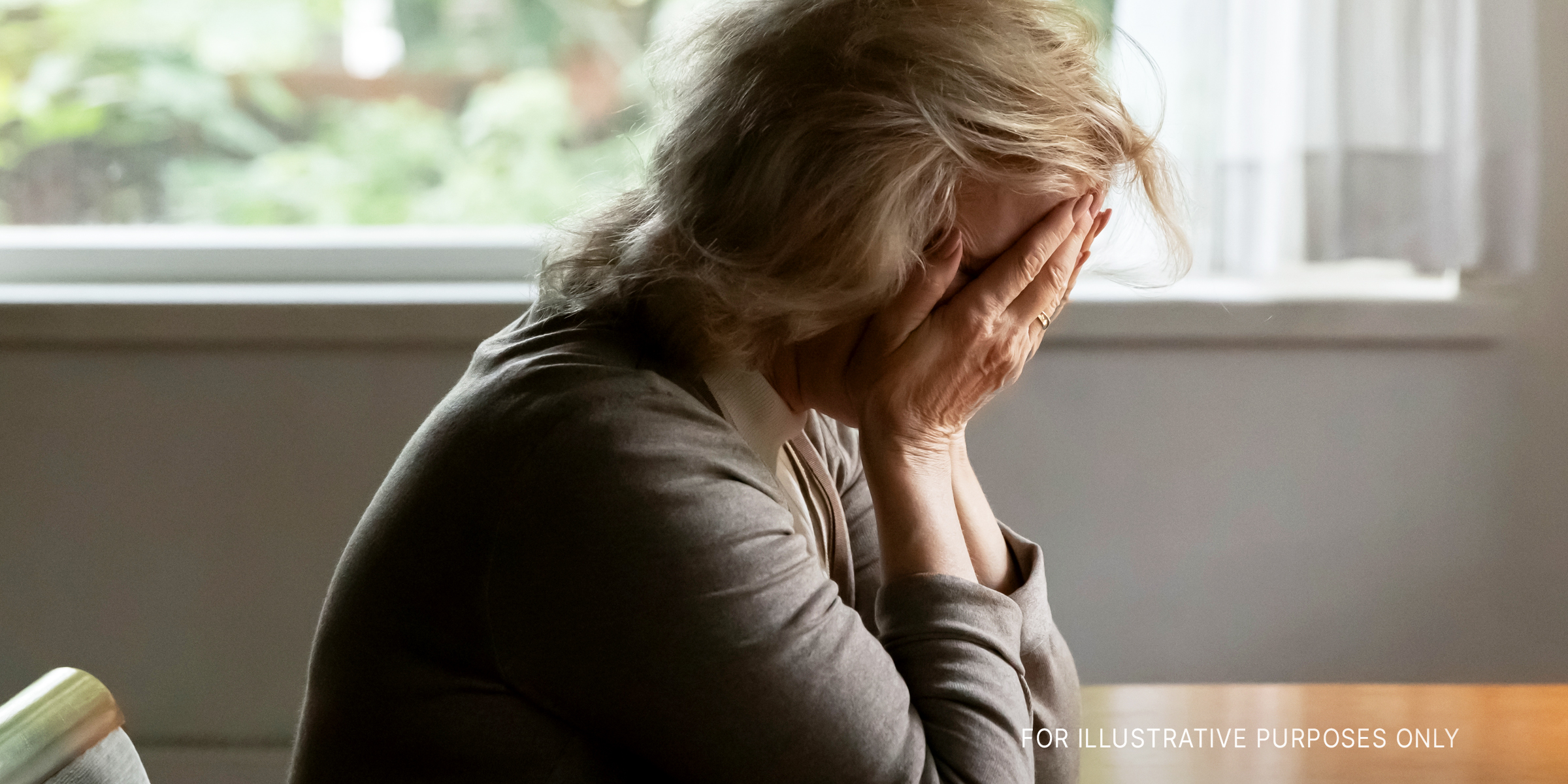 An older woman covering her face with her hands | Source: Shutterstock