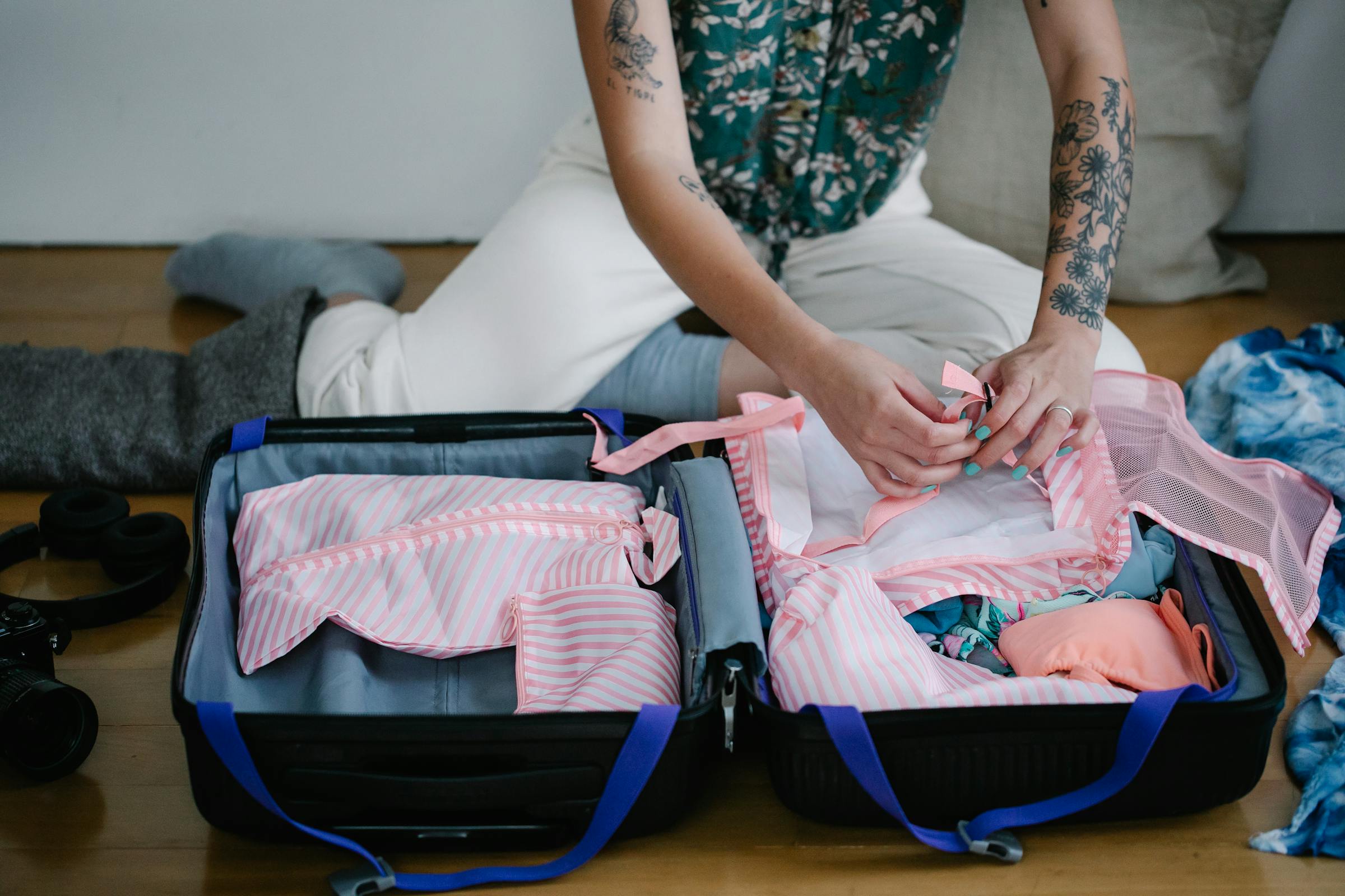 A woman packing clothes in a suitcase | Source: Pexels