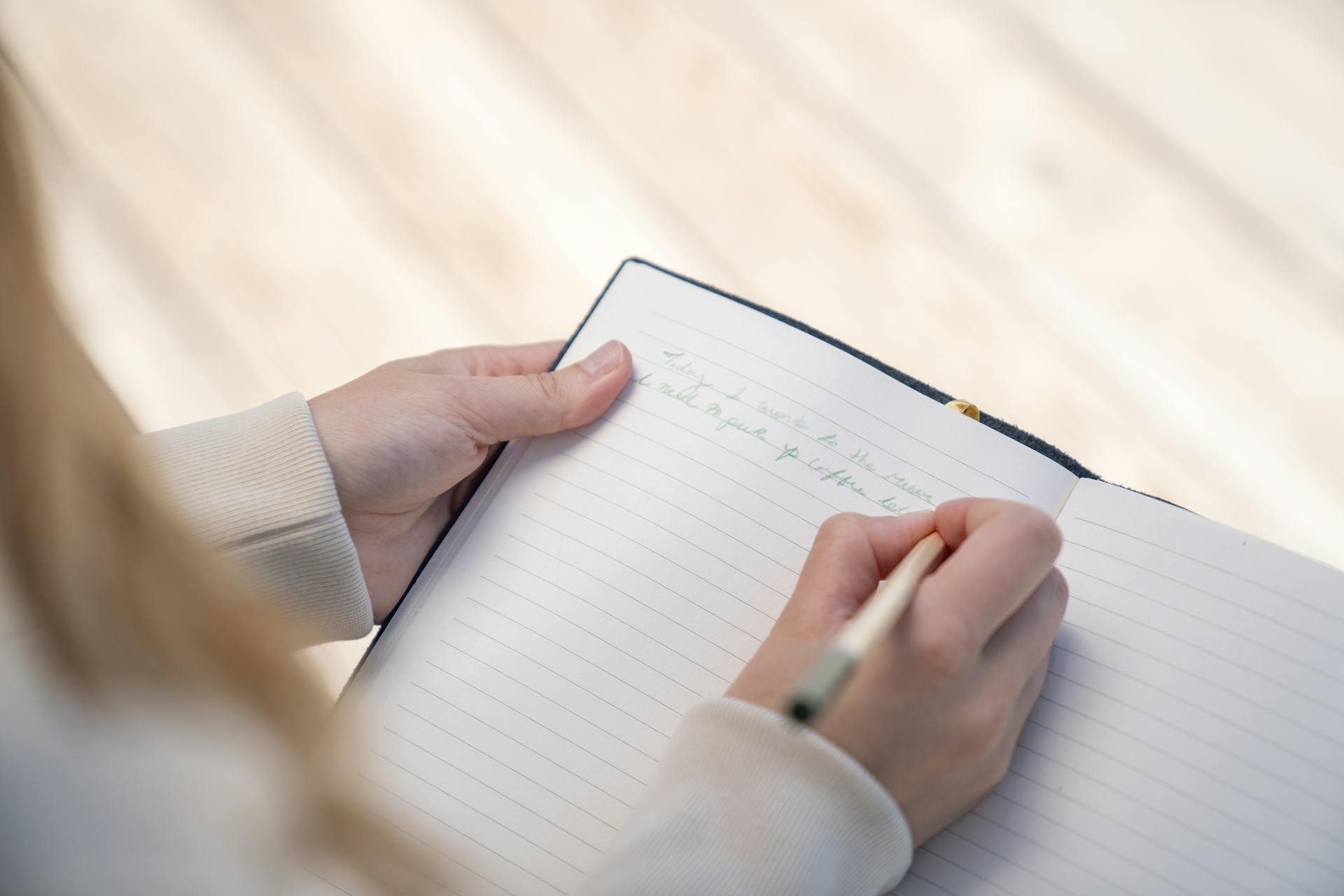 A close-up shot of a woman writing in a journal | Source: Pexels