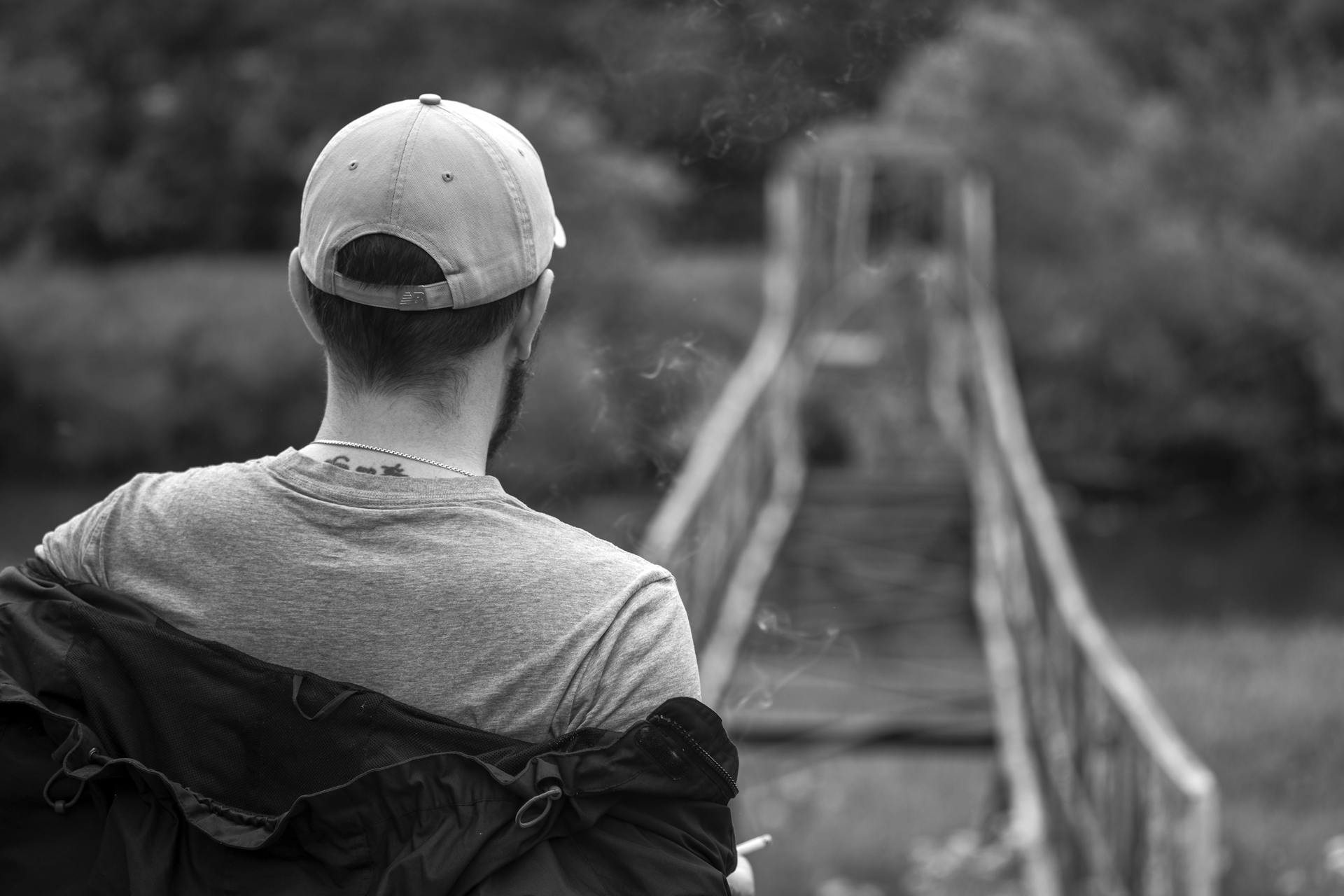 A back view of a man putting on a jacket | Source: Pexels