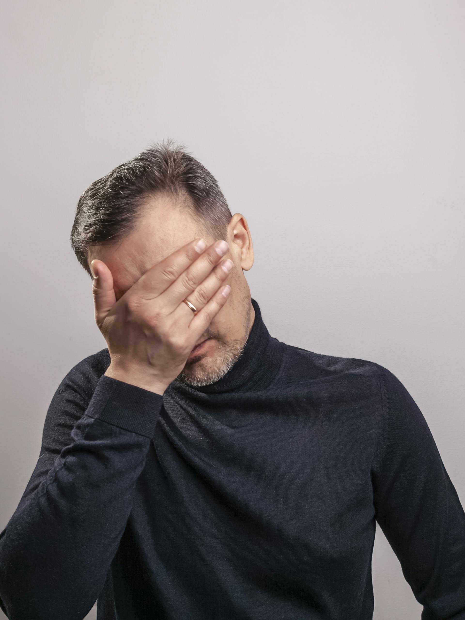 A man covering his face with his hand | Source: Pexels
