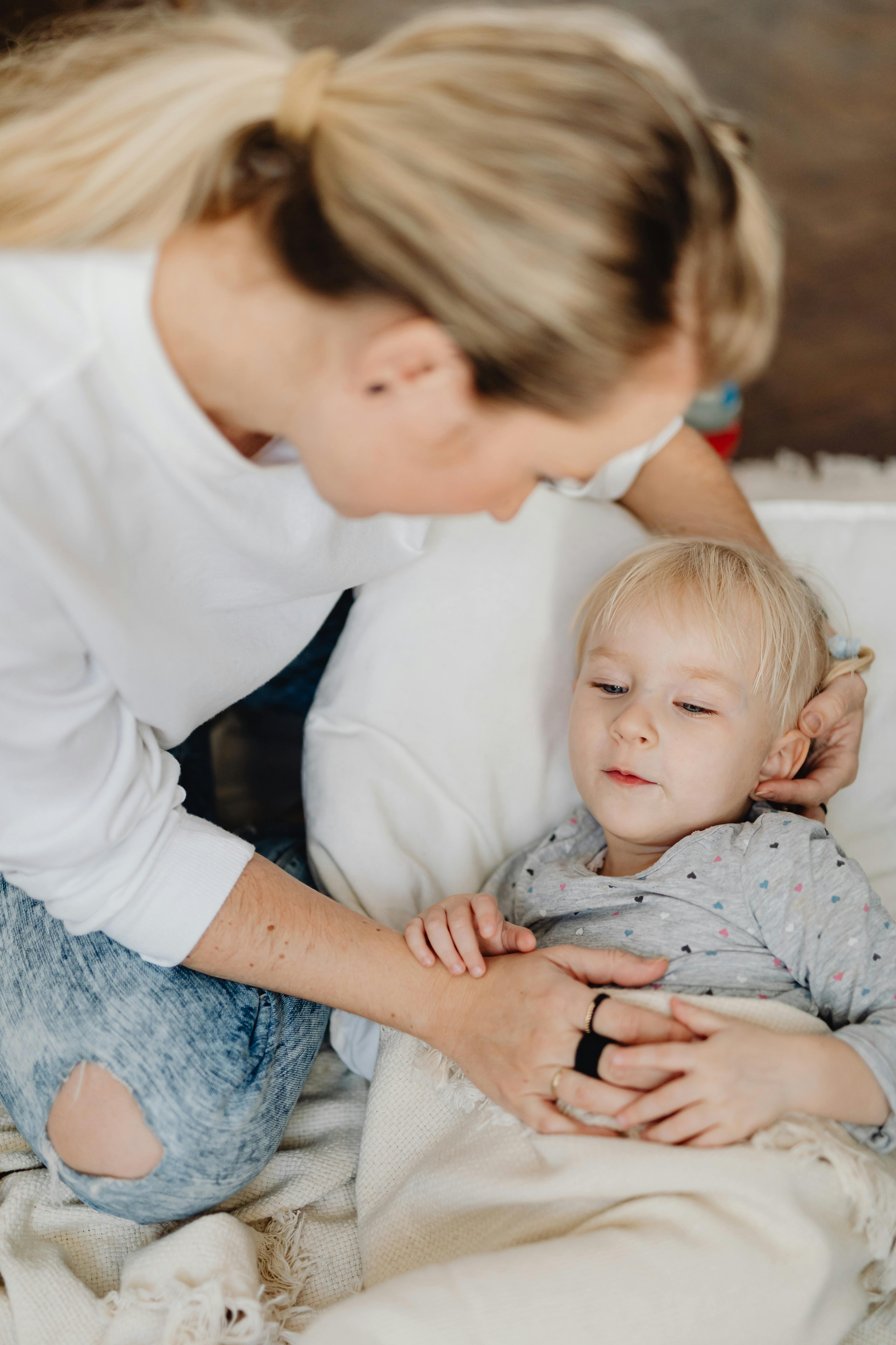 A mother looking down lovingly at her child | Source: Pexels