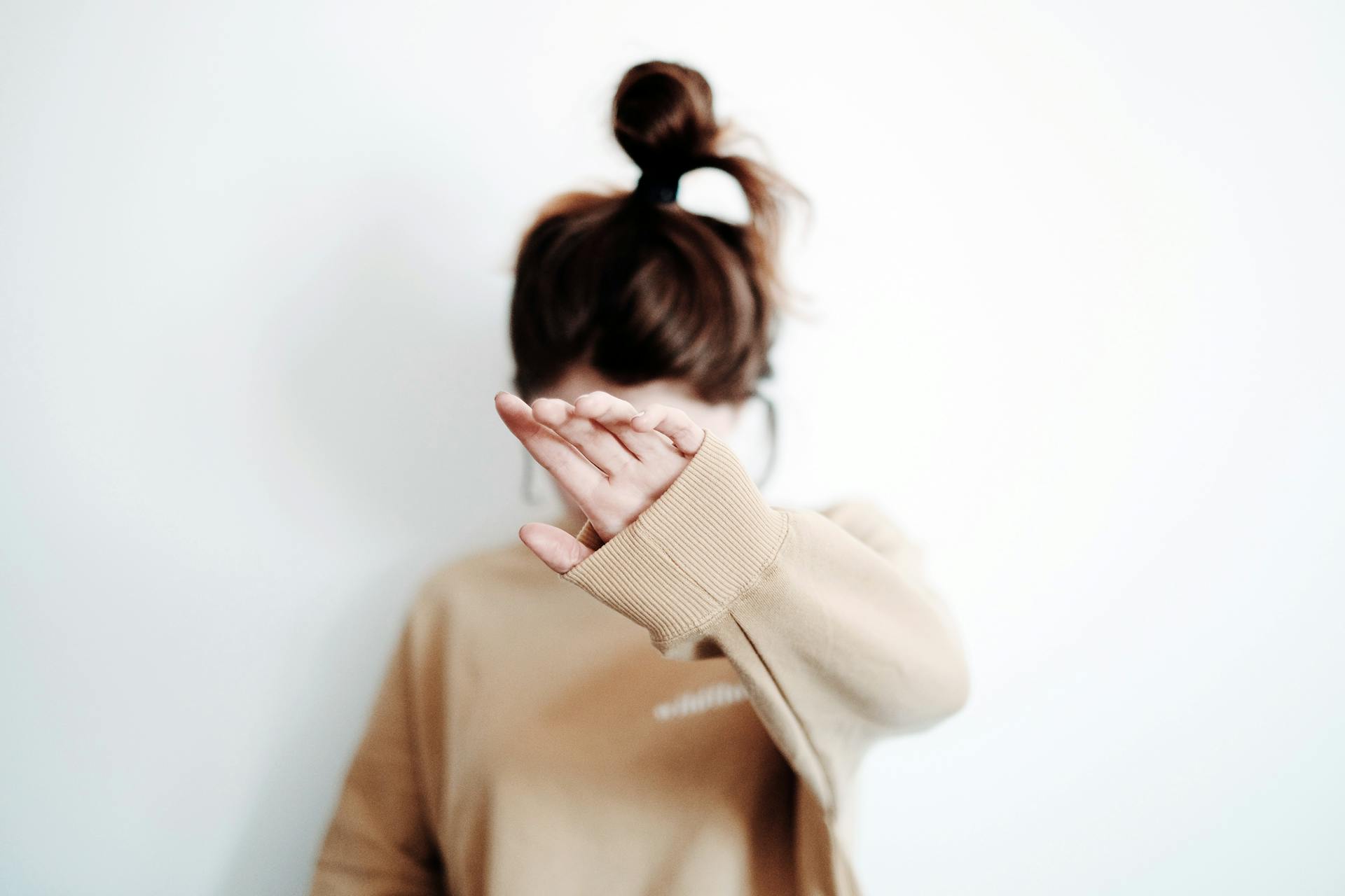 A girl hiding her face | Source: Pexels