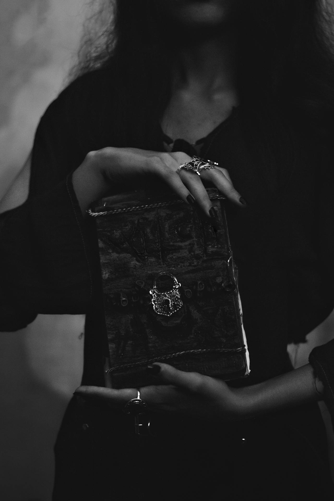 A woman holding a small locked box | Source: Pexels