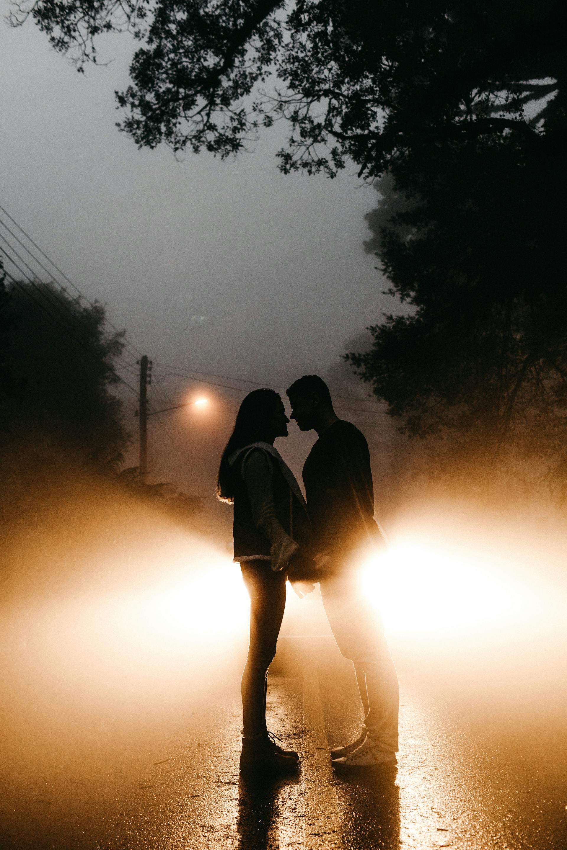 A distant shot of a couple standing on the road while holding hands | Source: Pexels