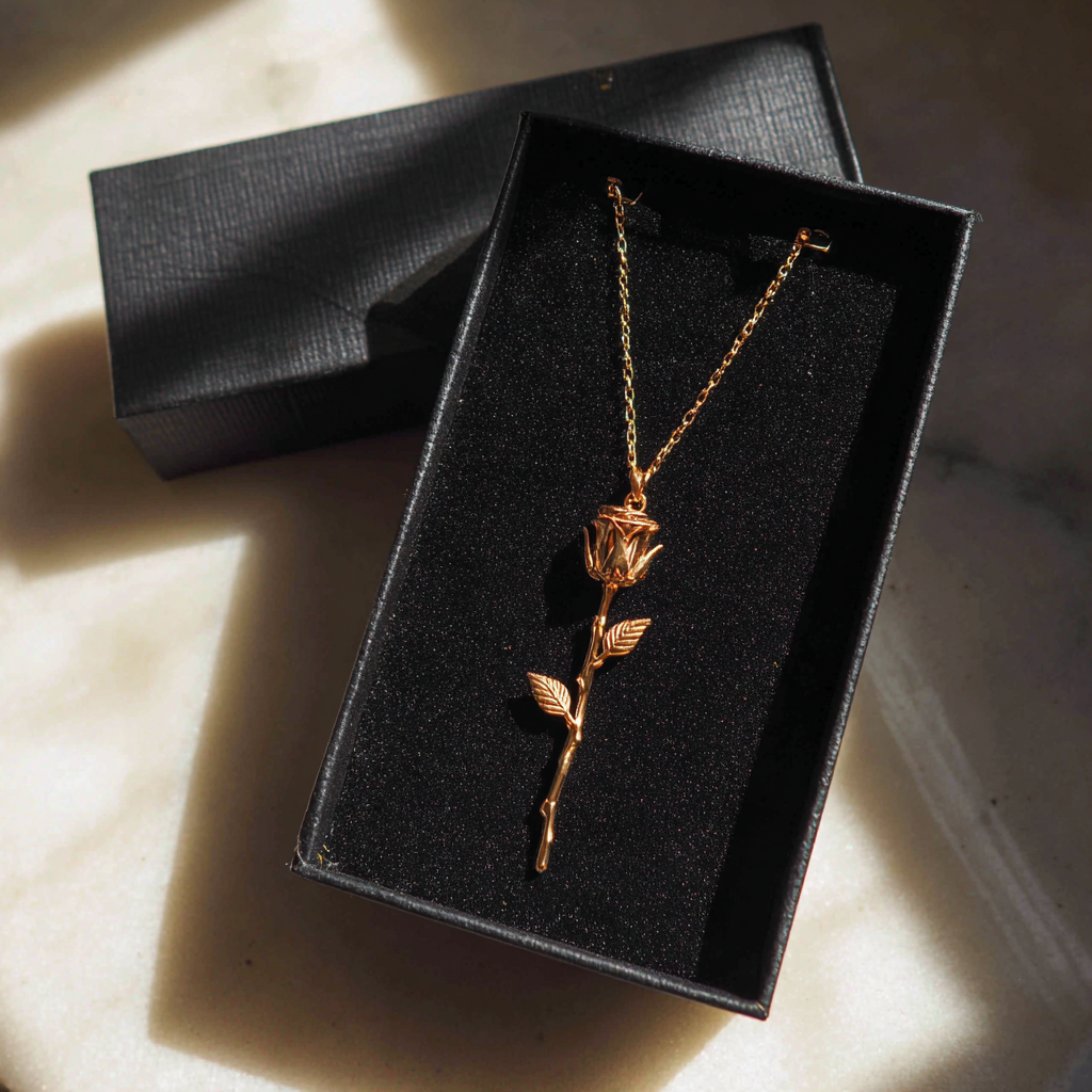 A gold necklace in a box | Source: Midjourney