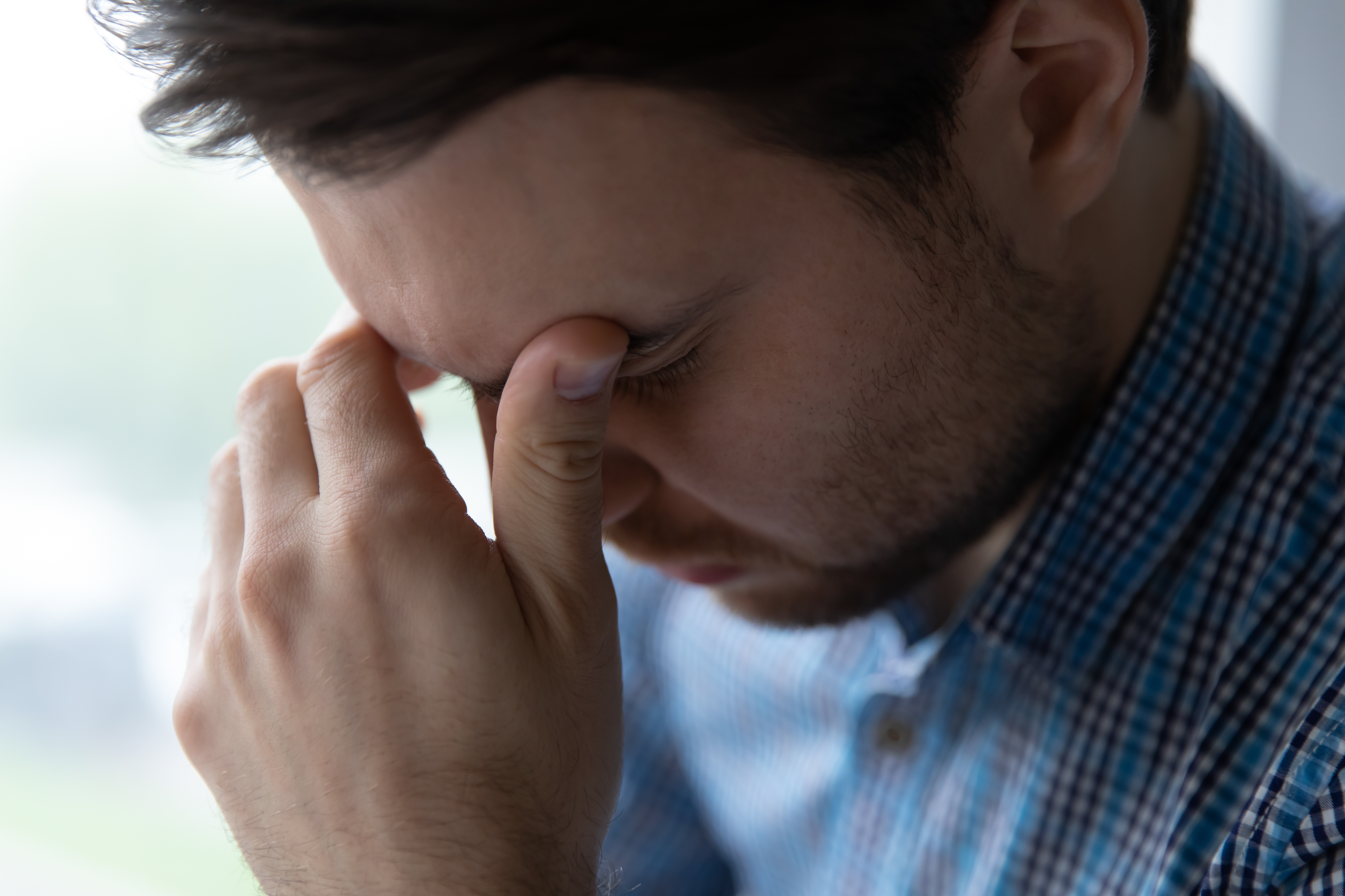 A close-up shot of a depressed man | Source: Shutterstock