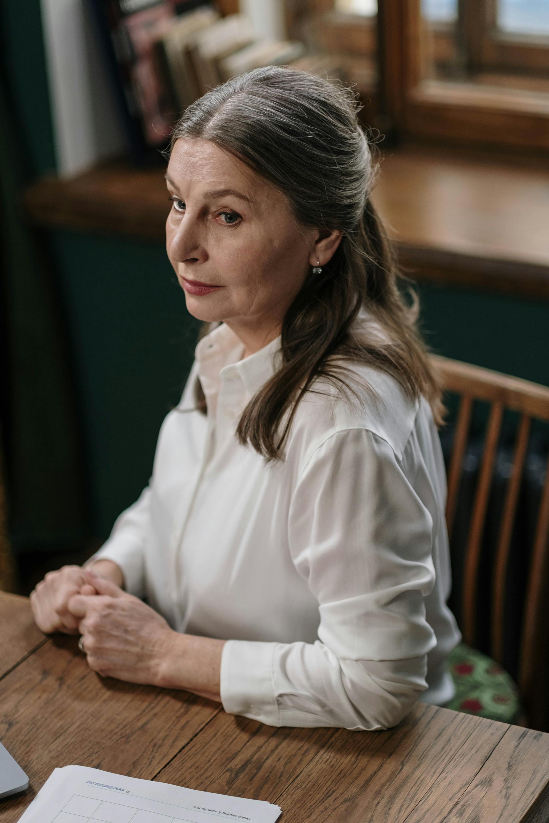 A woman sitting at a table | Source: Pexels