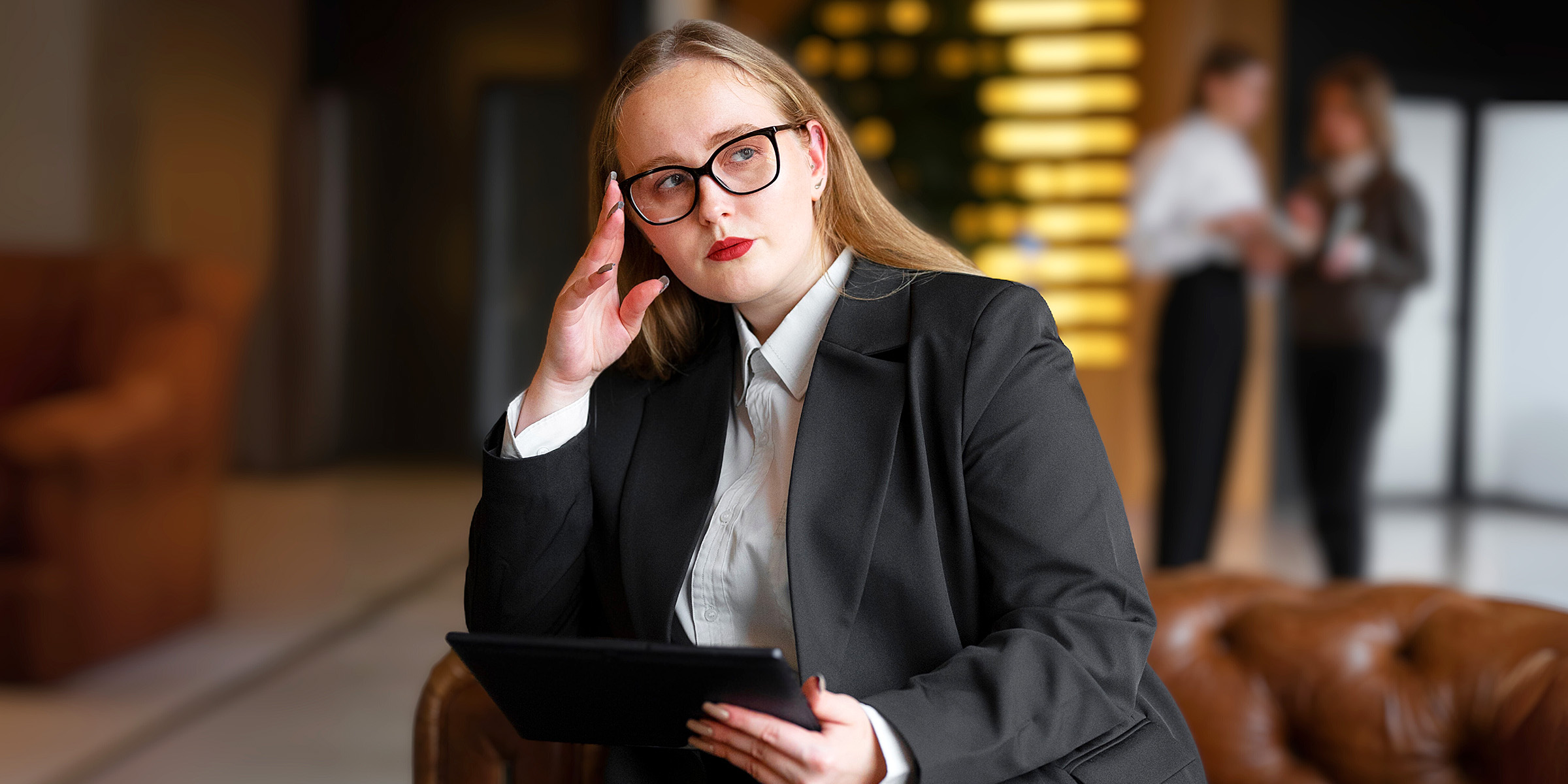 A woman sitting in a hotel lobby | Source: Freepik