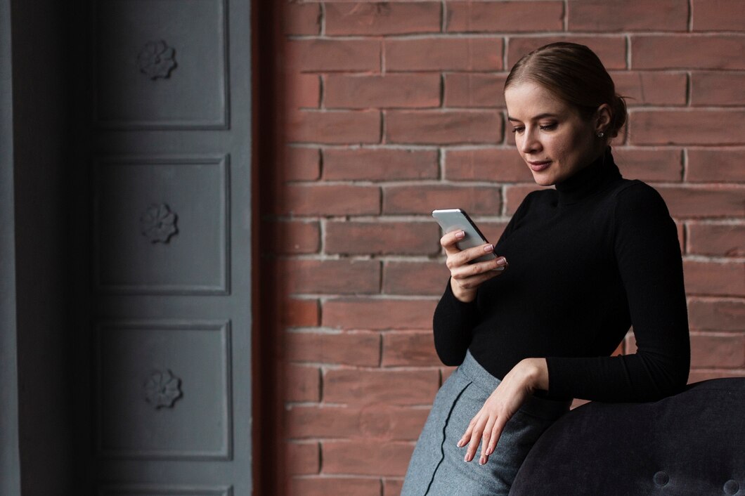 A serious woman on her phone | Source: Freepik