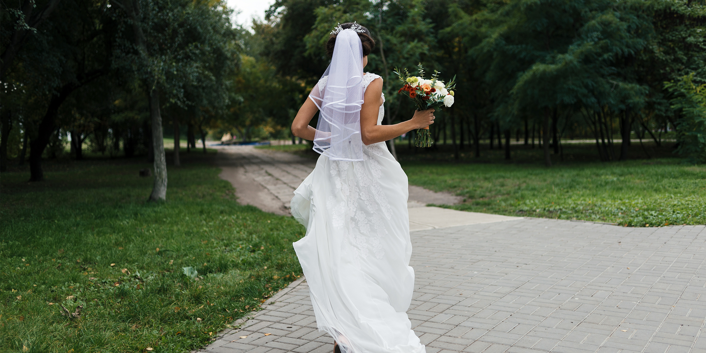 A bride running down a path | Source: Shutterstock