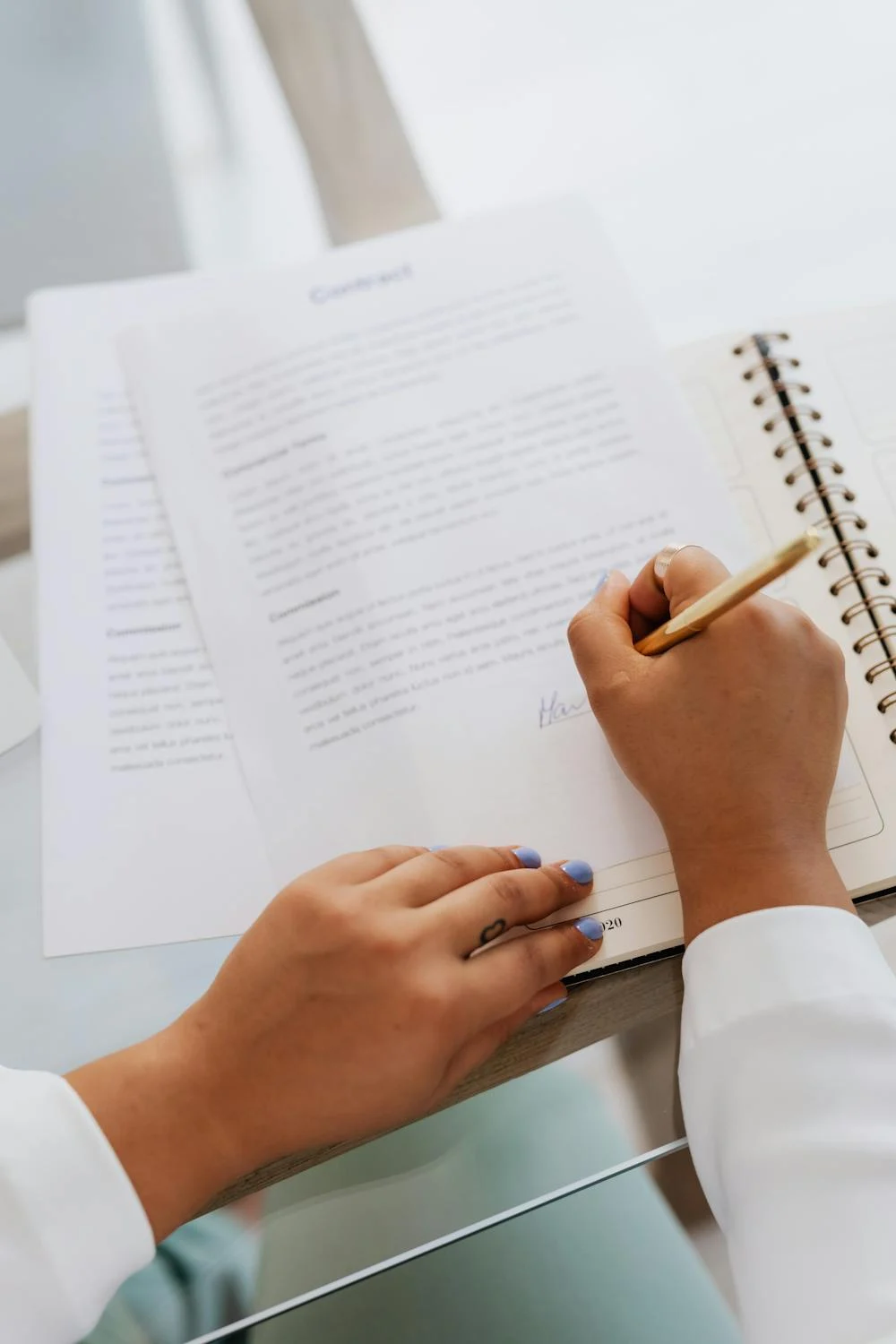 A woman signing papers | Source: Pexels