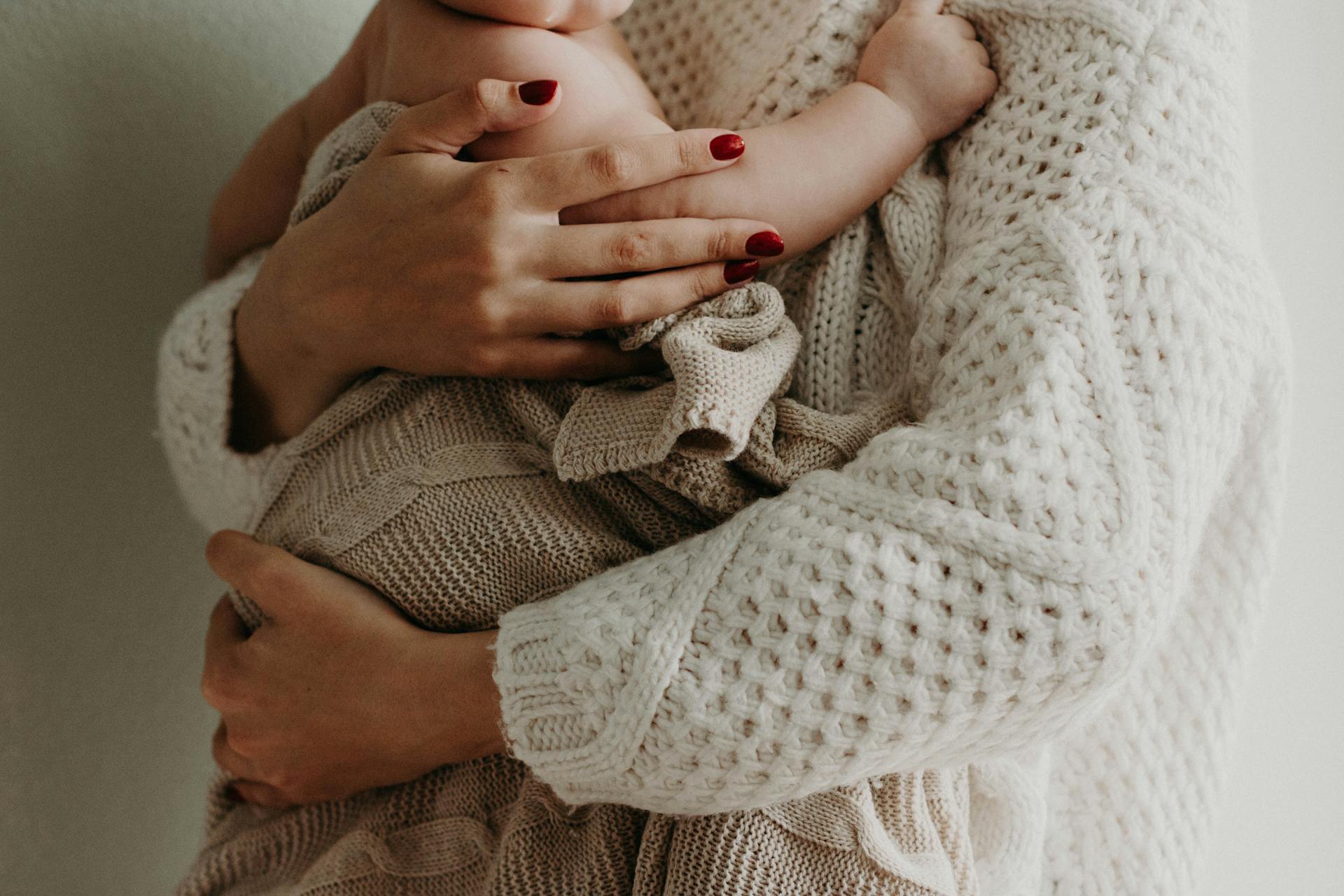 Close-up cropped shot of a mother holding a baby | Source: Pexels