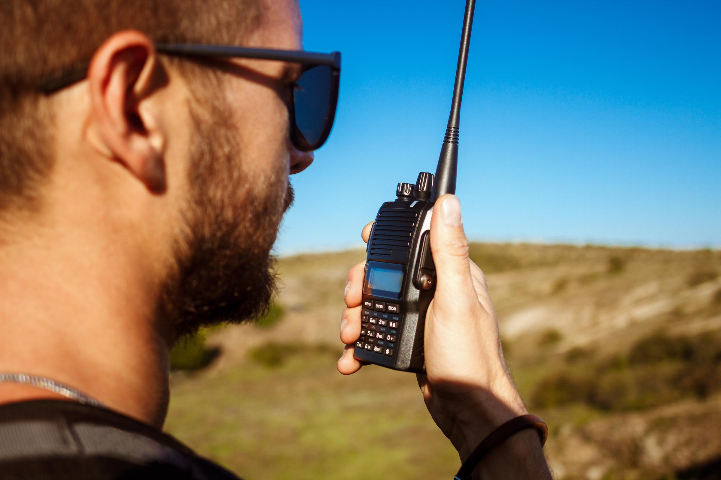 A man on a hand-held radio | Source: Freepik