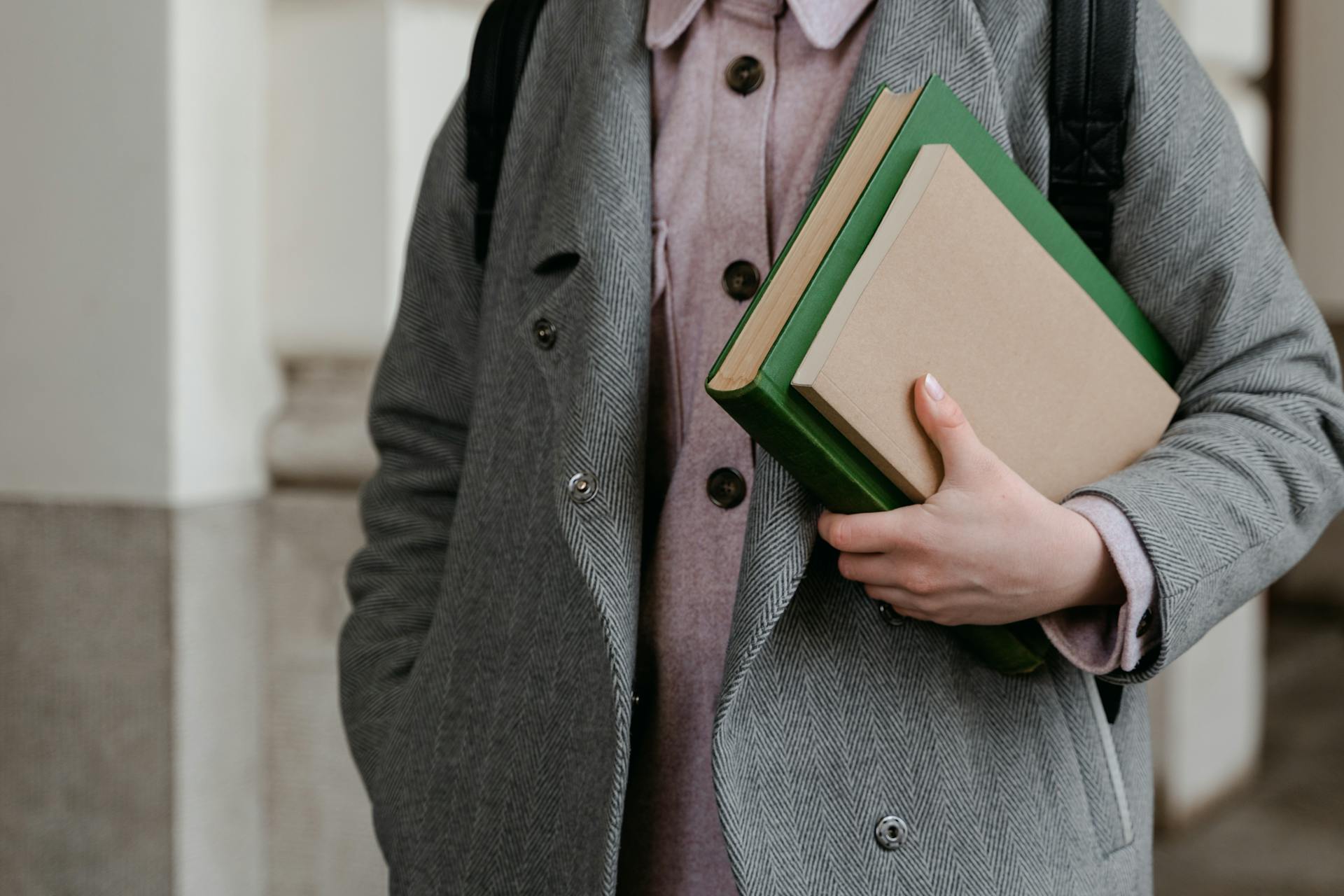 A person holding a couple of books | Source: Pexels