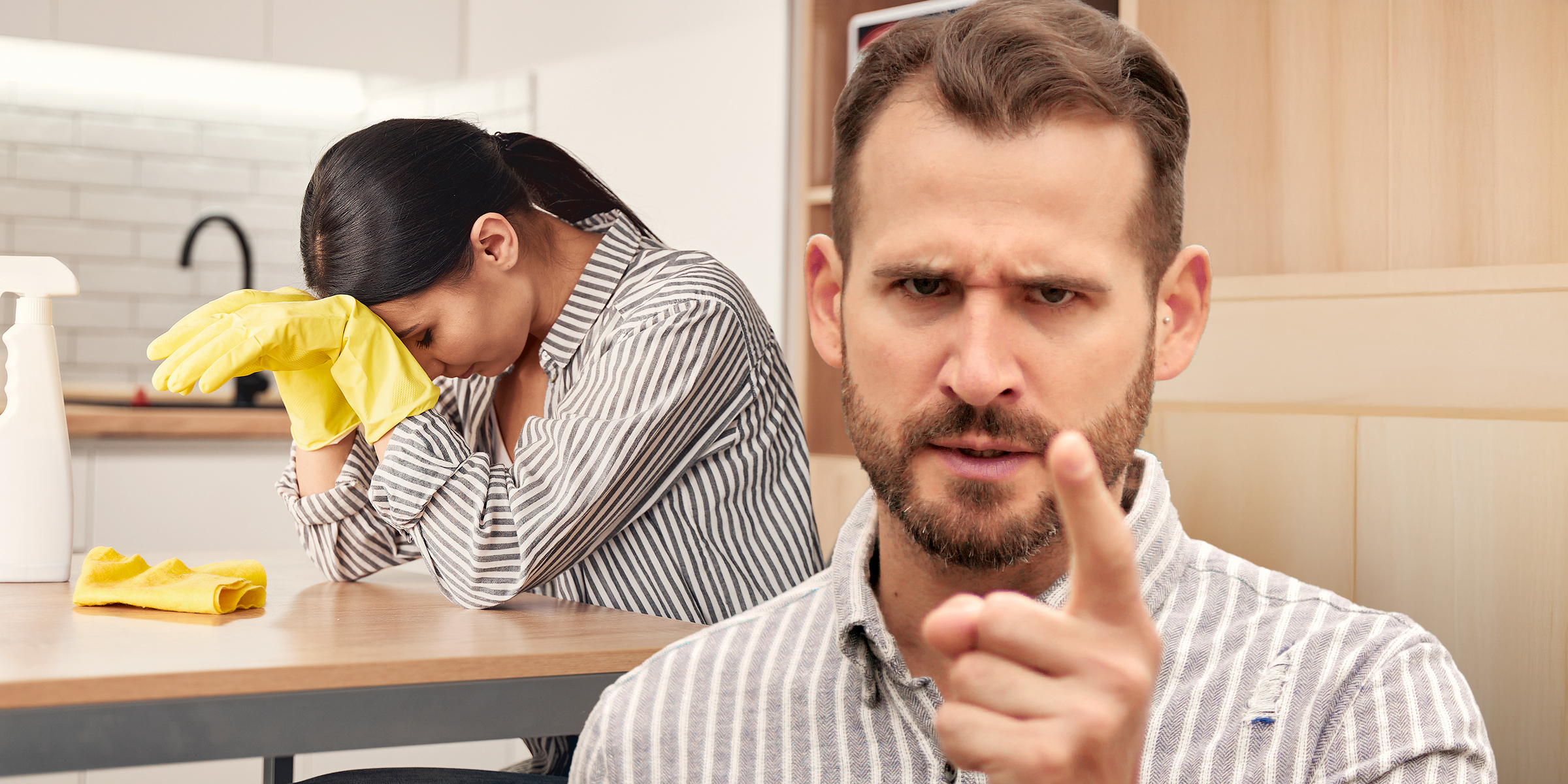 A frustrated woman trying to clean while her husband shouts | Source: Shutterstock