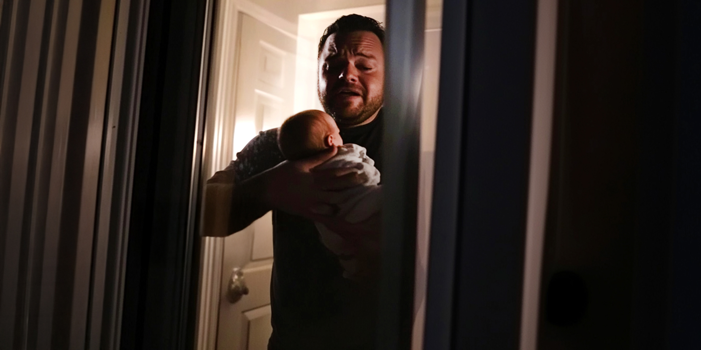 An upset man holding a baby | Source: The Celebritist