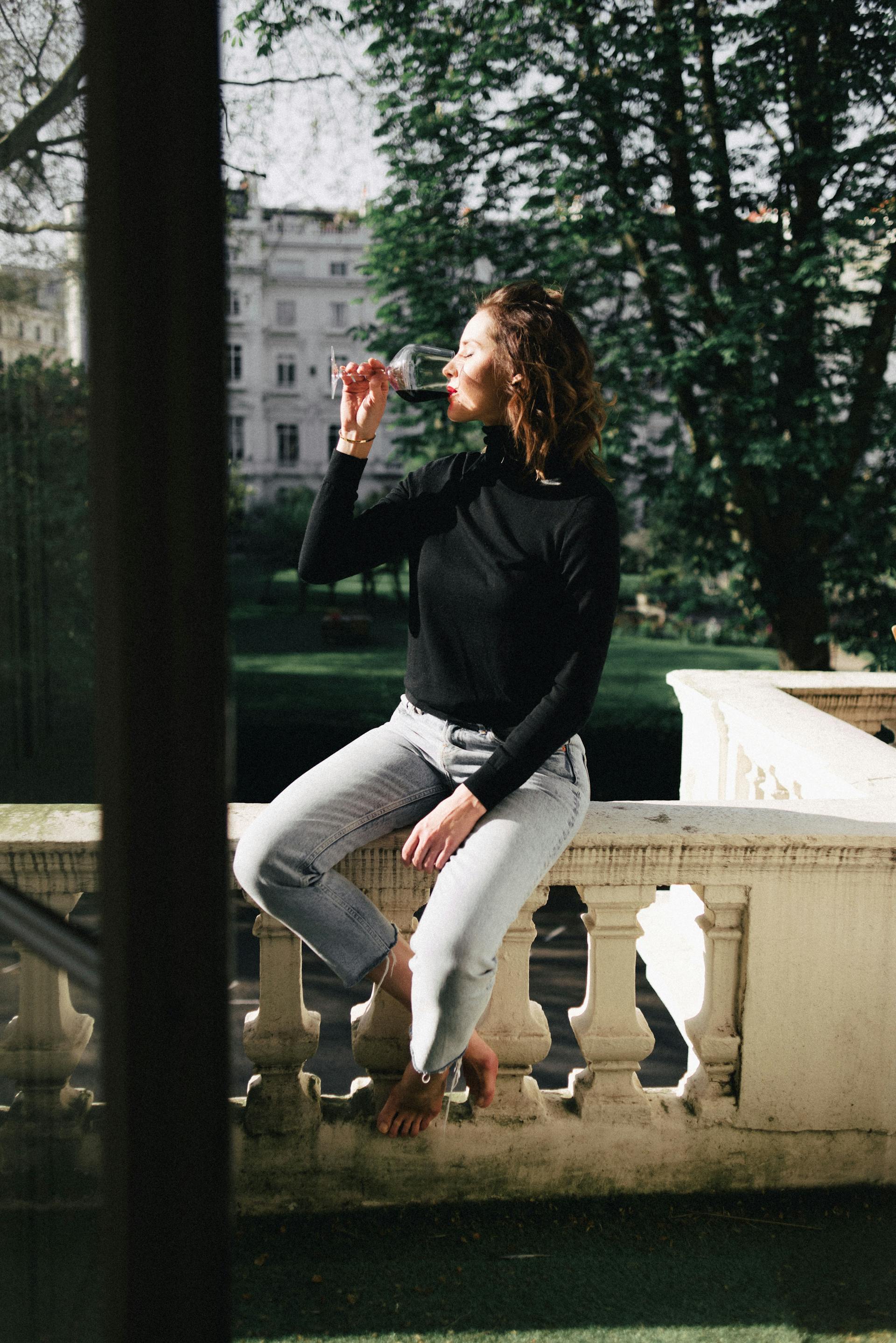 A happy woman sipping wine | Source: Pexels