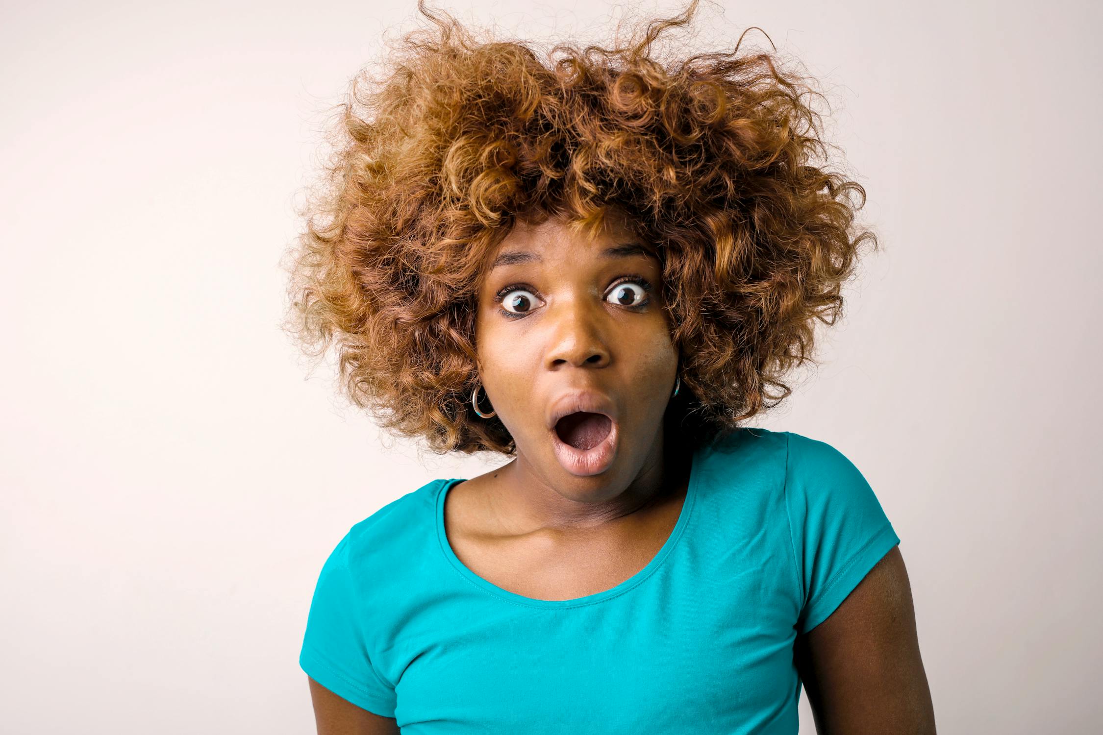 A shocked woman in a blue T-shirt | Source: Pexels