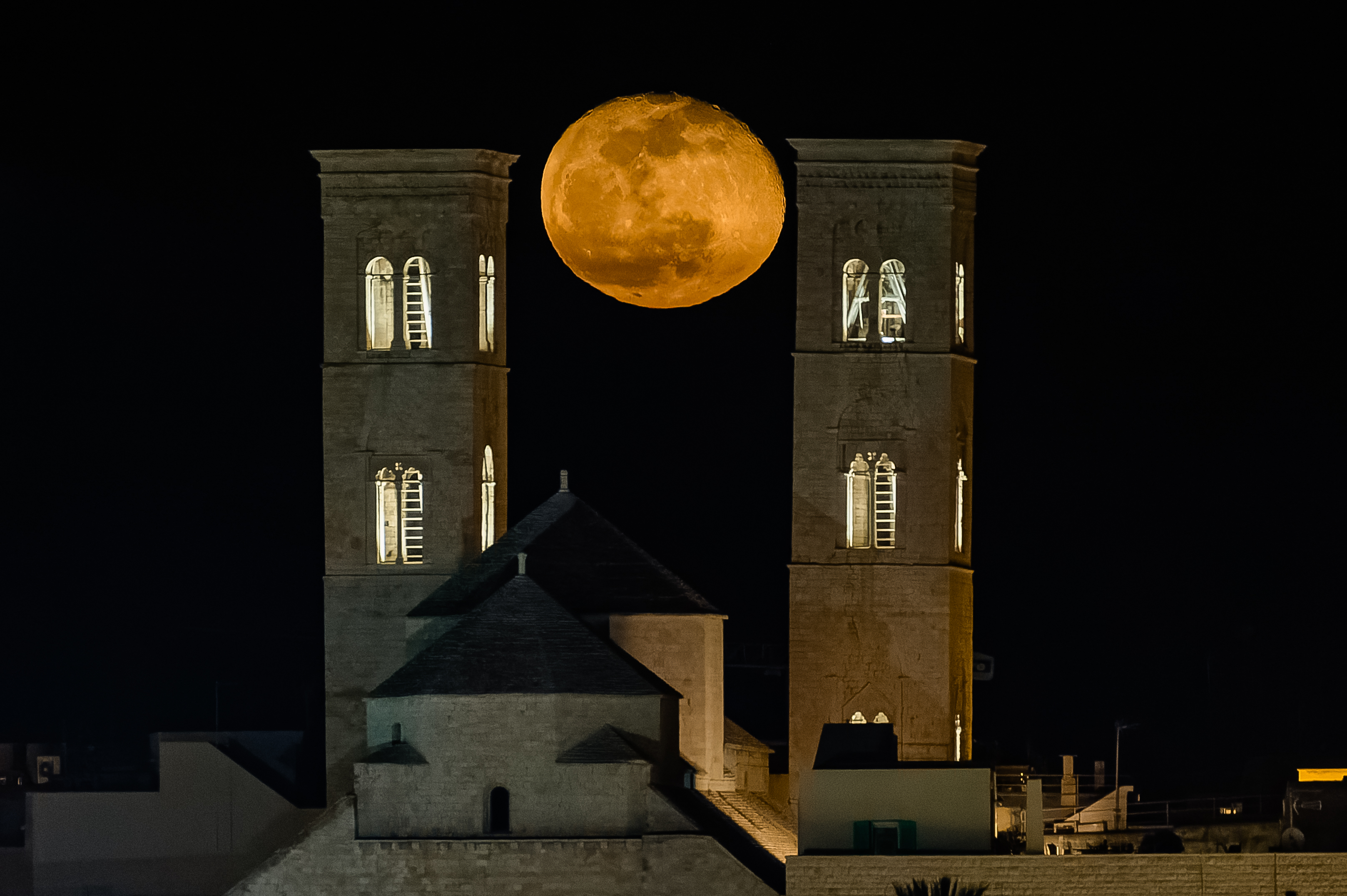 The full moon is rising behind the towers of Molfetta Cathedral in Molfetta, Italy, on February 26, 2024 | Source: Getty Images