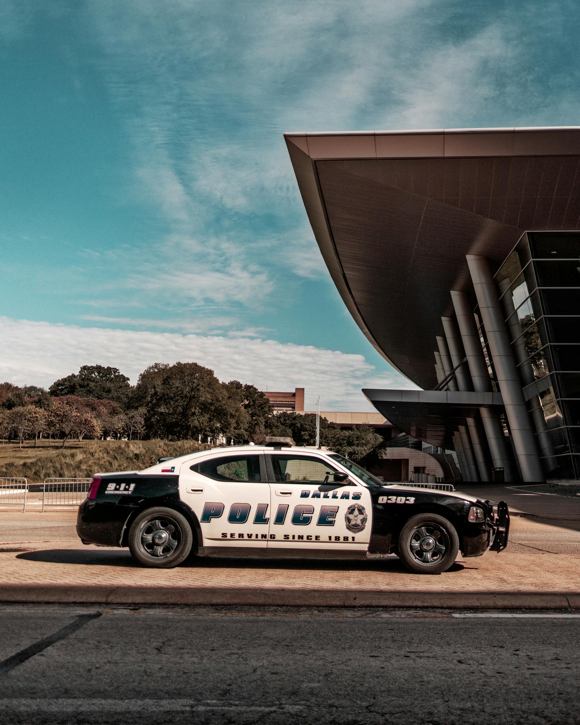 Un coche de policía estacionado frente a un edificio | Fuente: Pexels