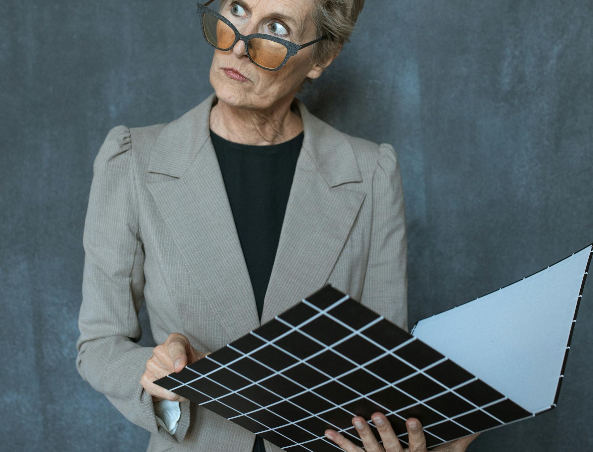 An older lady holding a folder | Source: Pexels