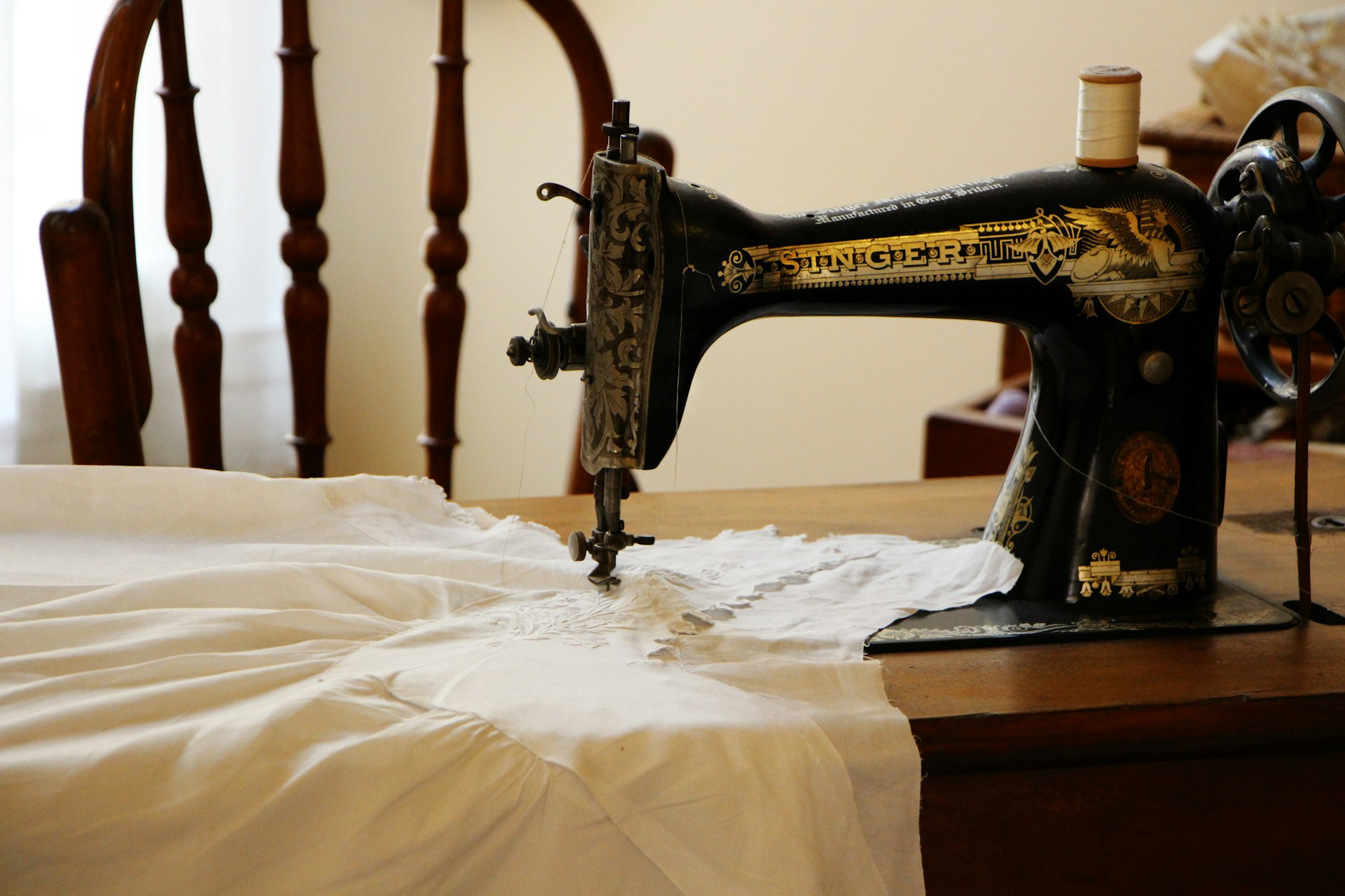 My Sister Excluded My Son from Her Wedding After He Made Her Dress, but Still Expected to Wear It – We Gave Her One Condition to Keep It 6 A white garment being stitched using a sewing machine | Source: Unsplash