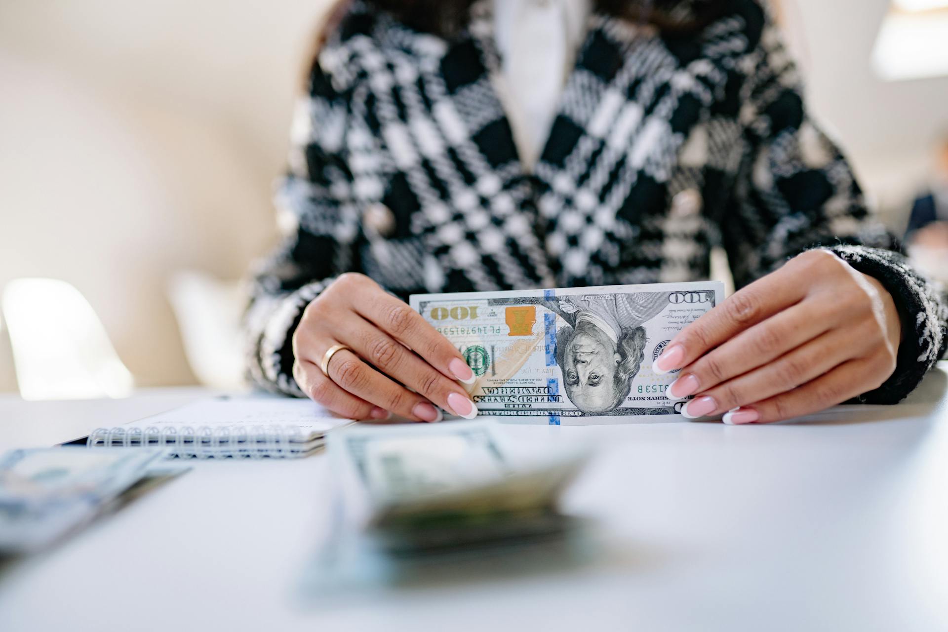 A woman holding money | Source: Pexels