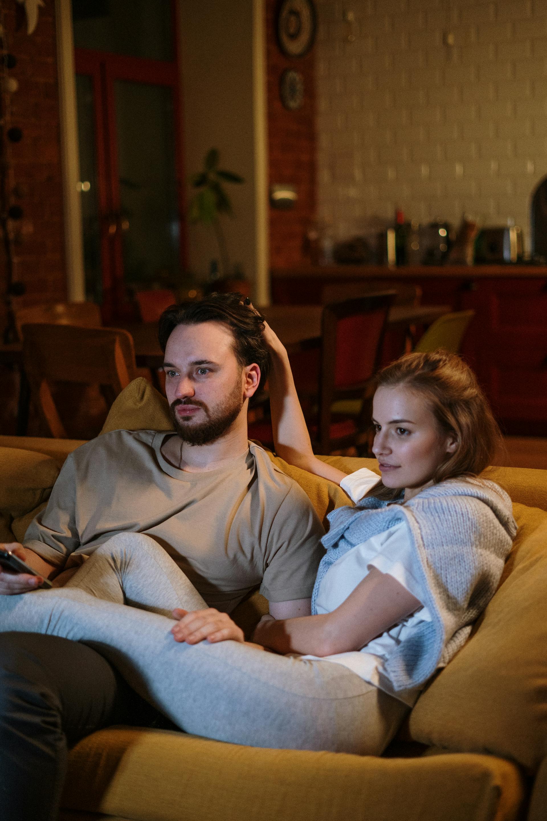 A couple sitting on a sofa together | Source: Pexels