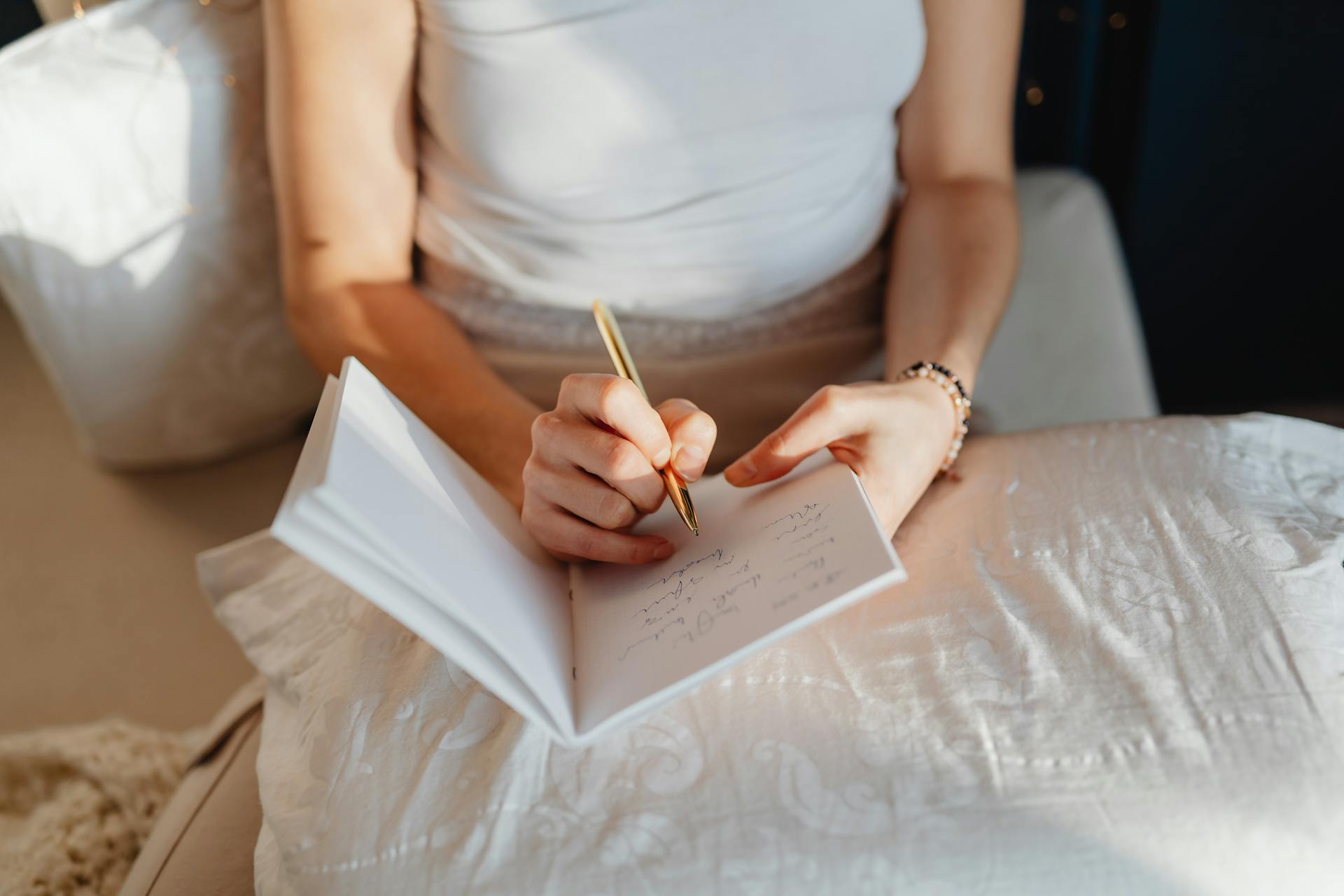 A woman writing something | Source: Pexels