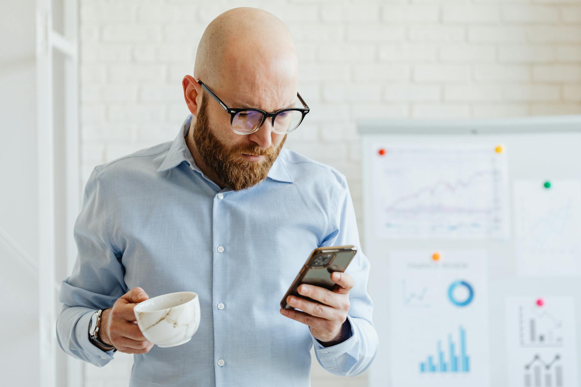 A shaken man looking at his phone | Source: Pexels