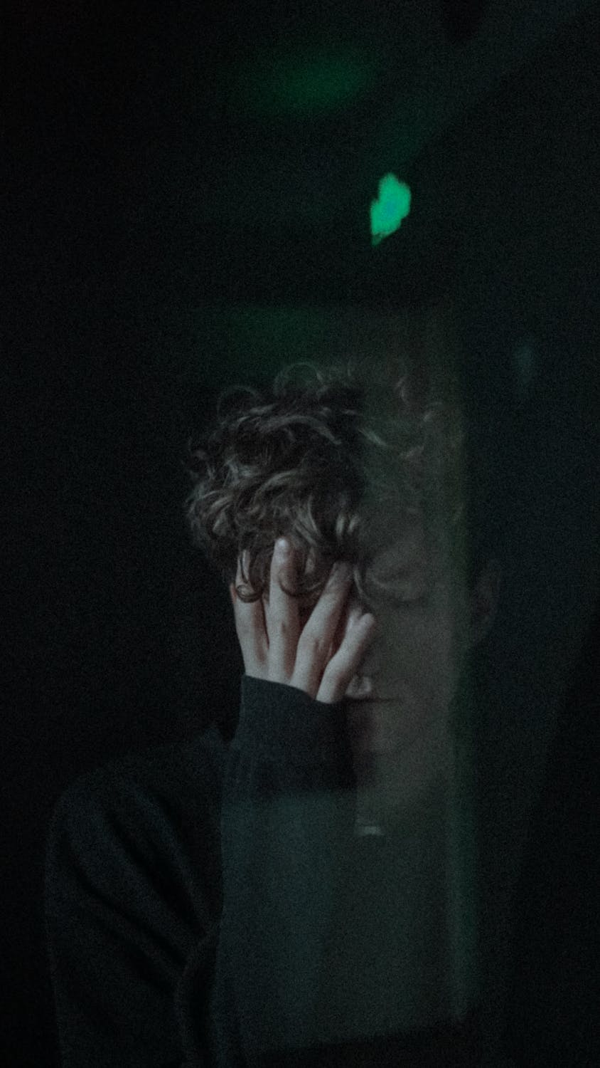 A sad man covering his face | Source: Pexels