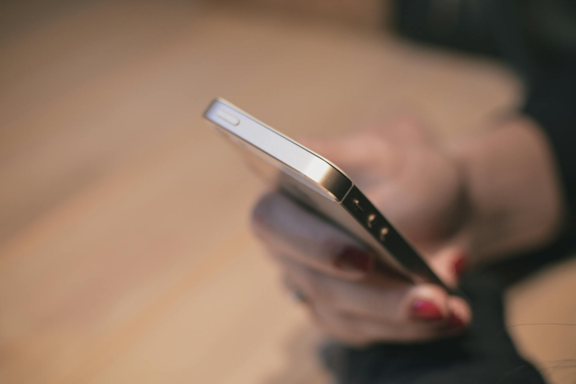 A woman reading messages on her son's phone | Source: Pexels