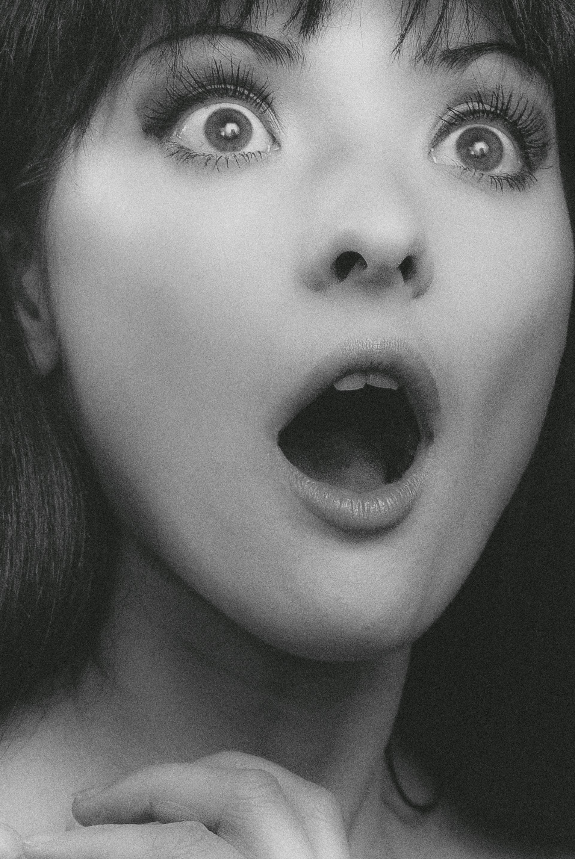 A grayscale photo of a surprised young woman | Source: Pexels