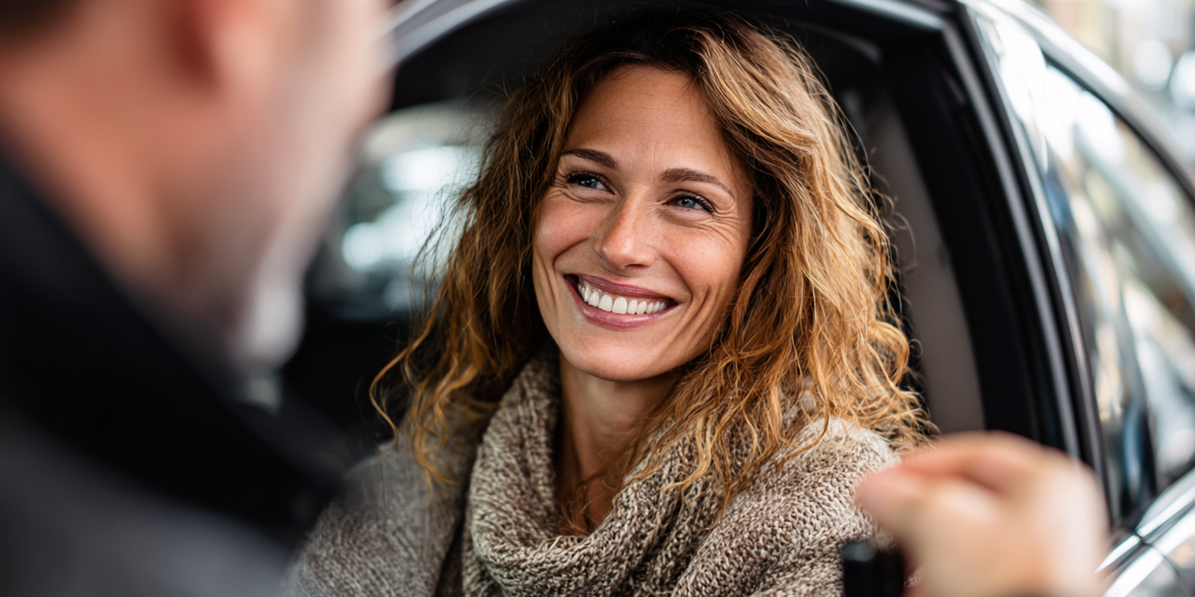 Happy woman getting car keys | Source: Midjourney