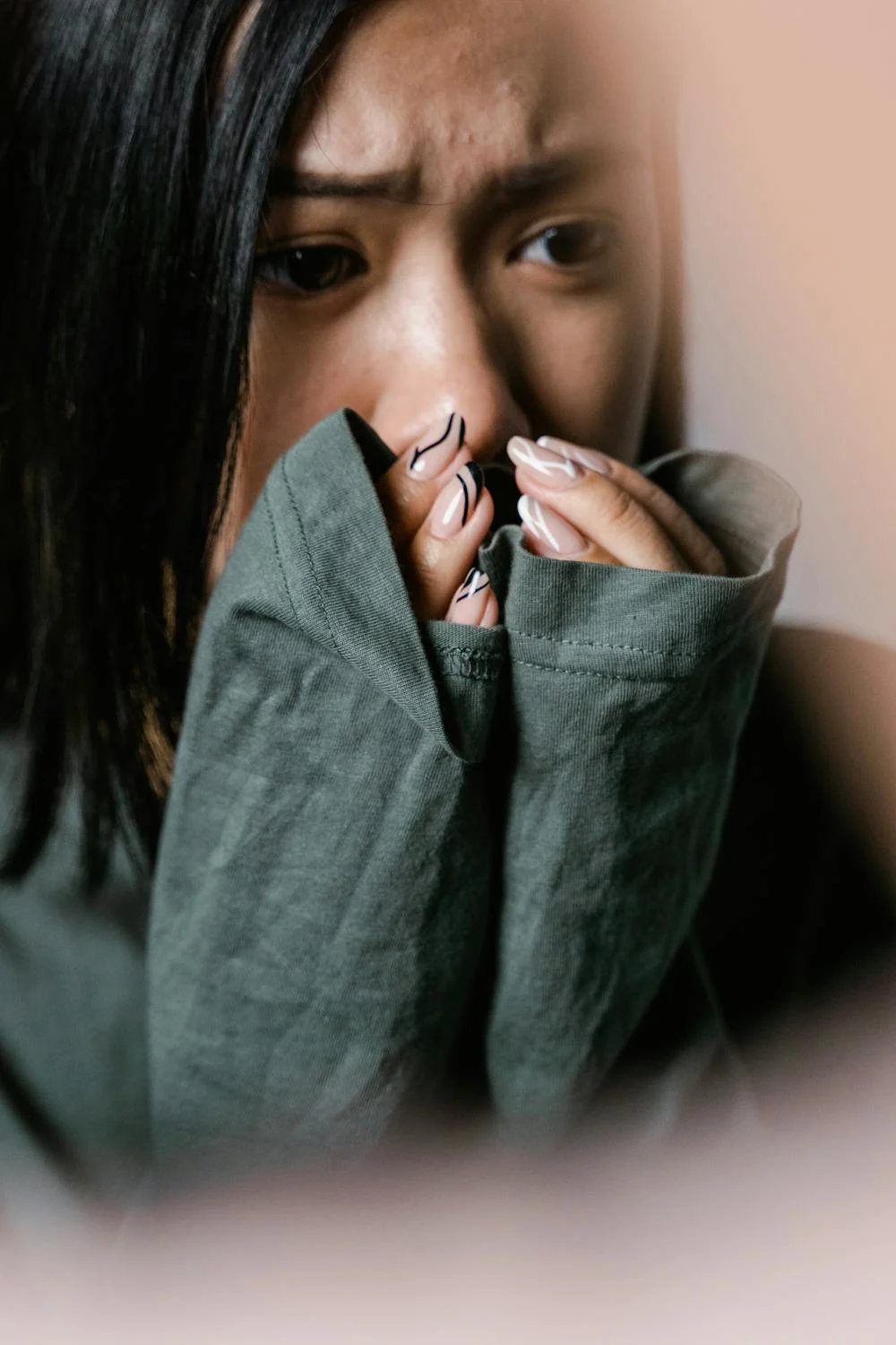 A scared woman covering her mouth with her hands | Source: Pexels