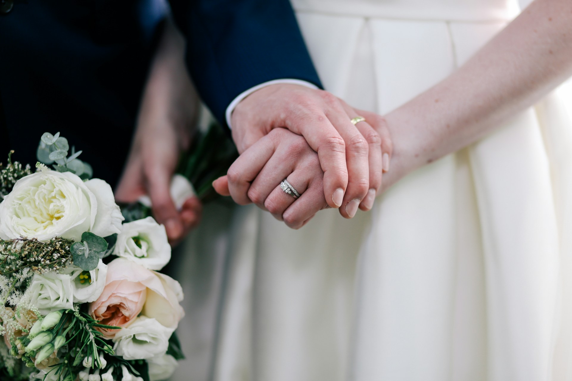 A groom holding a bride's hand | Source: Unsplash