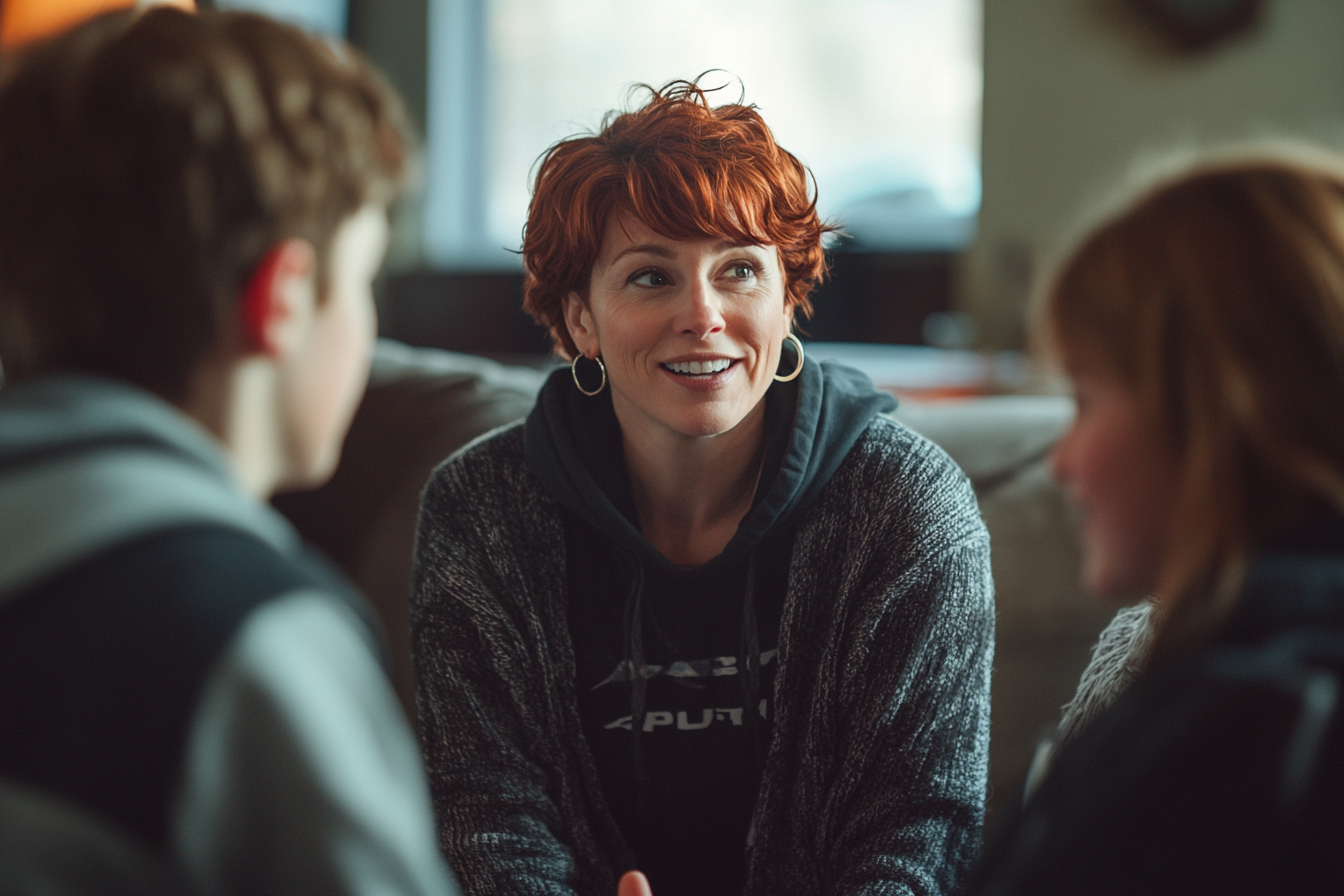 Woman in her 30s talking to her teenage kids on a couch | Source: Midjourney