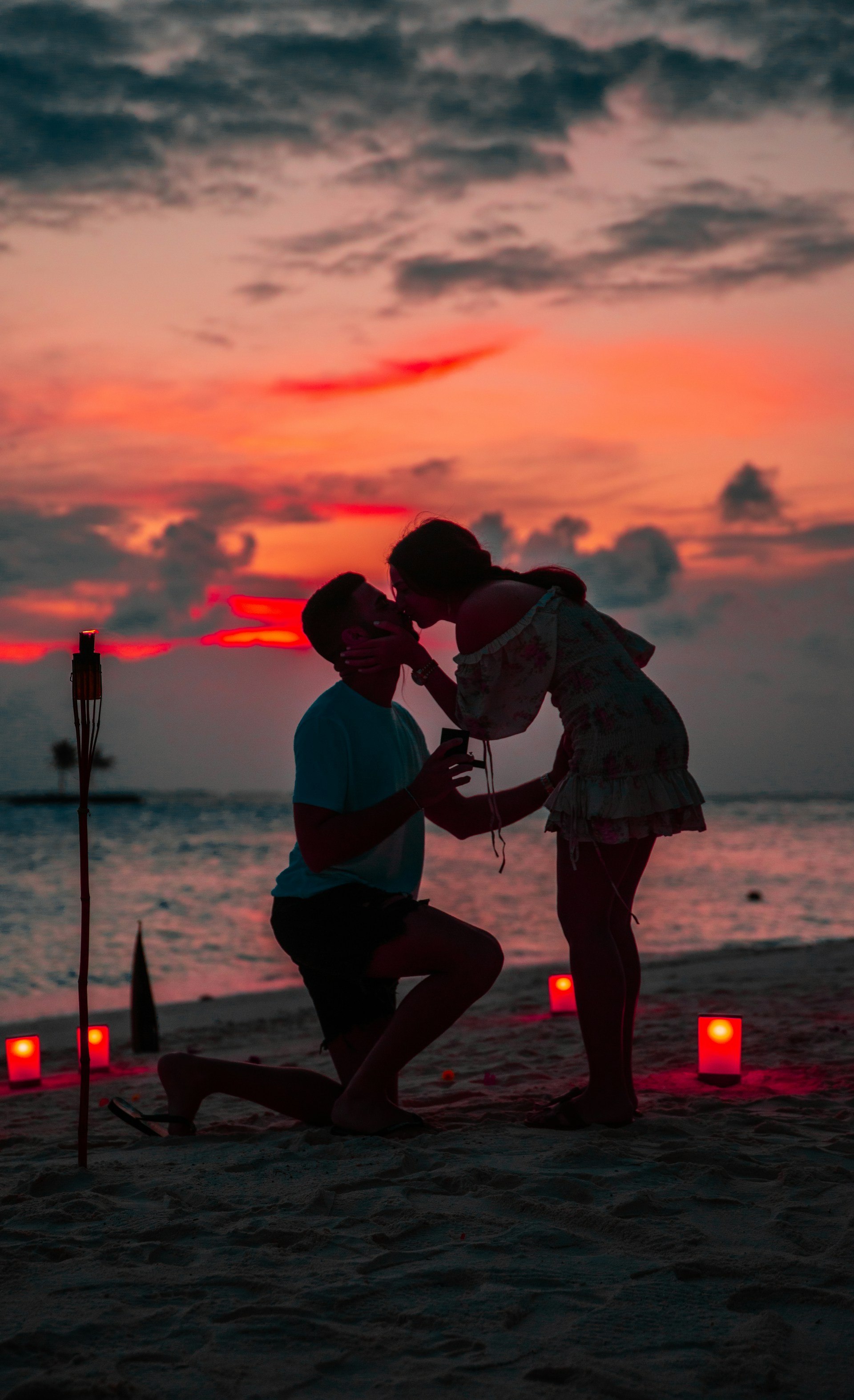 A man down on one knee with a ring while his partner kisses him | Source: Unsplash