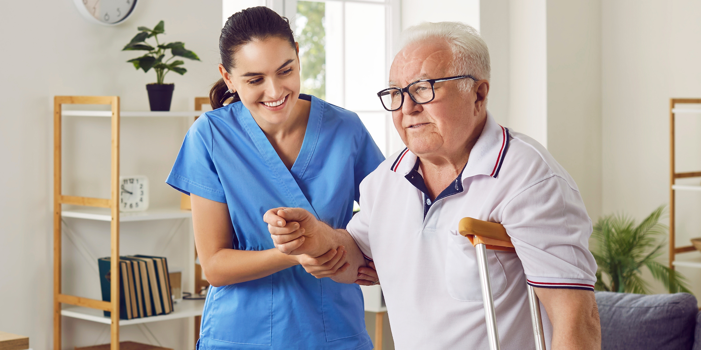 A caregiver taking care of an elderly man | Source: Shutterstock