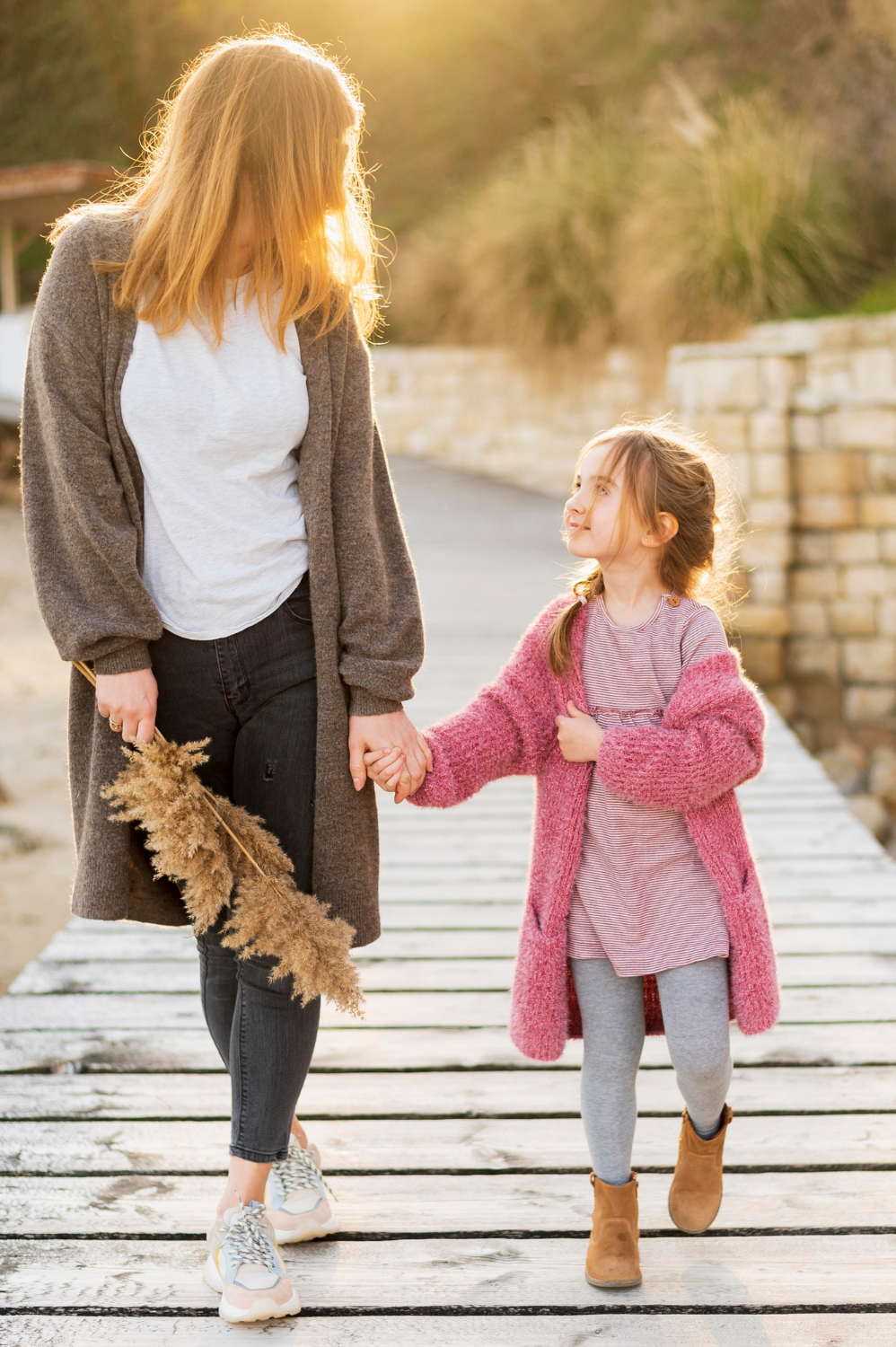 A woman walking with her daughter | Source: Freepik