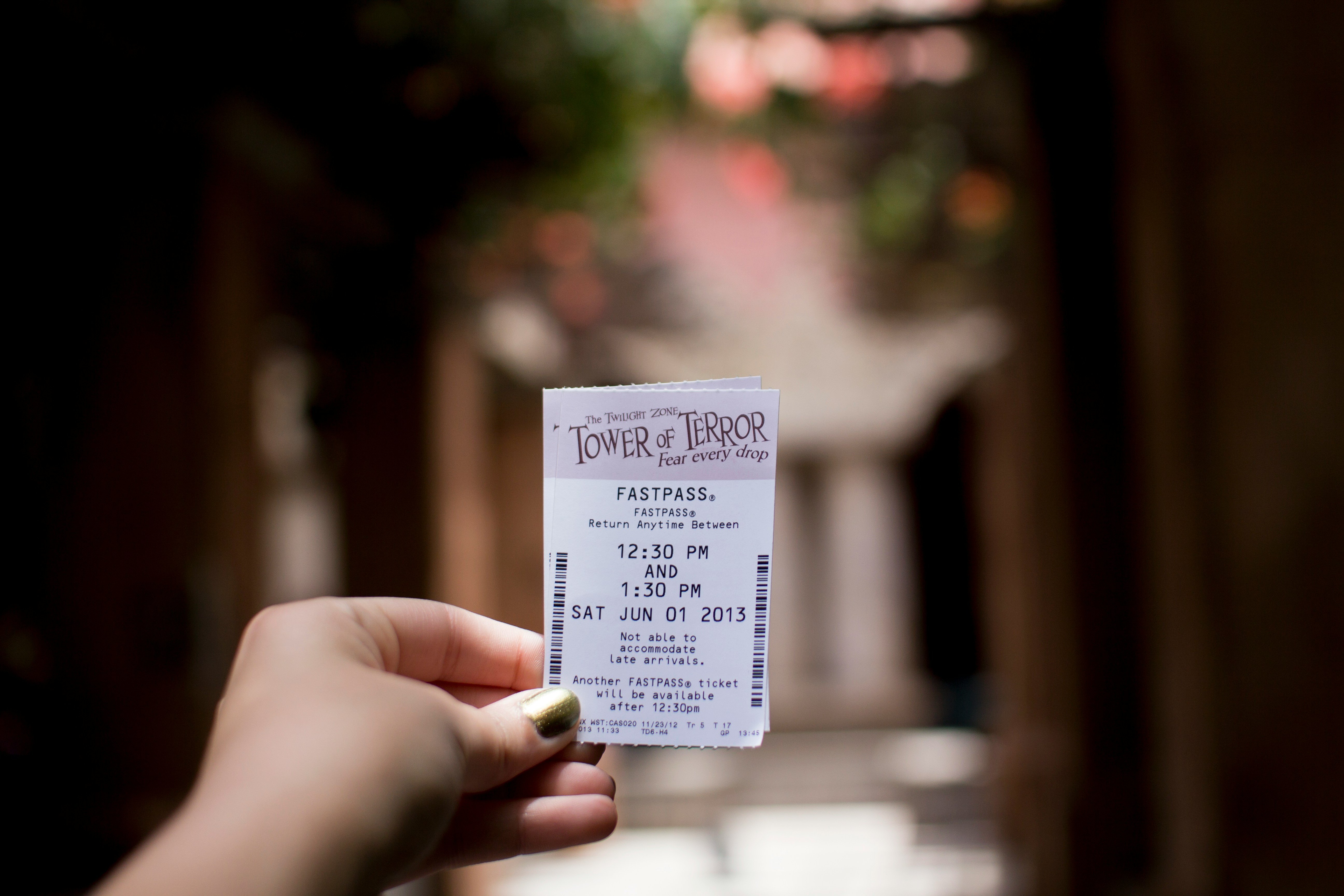 A woman's hand holding a ticket to an event | Source: Unsplash