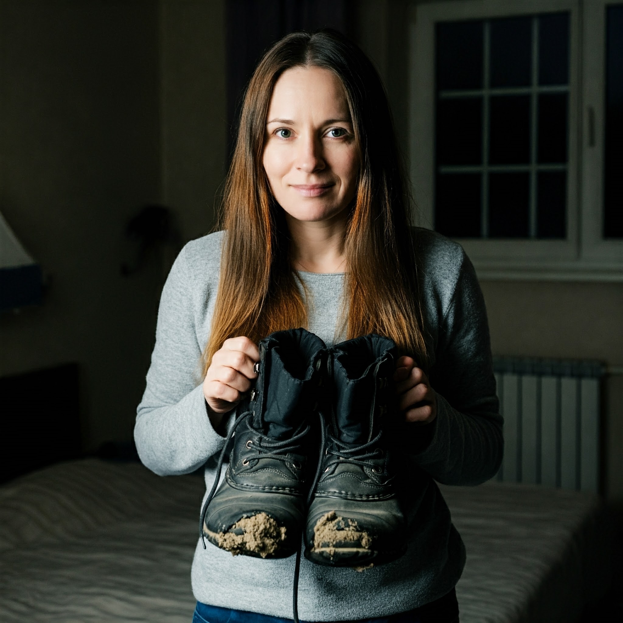 A woman holding worn winter boots | Source: Gemini